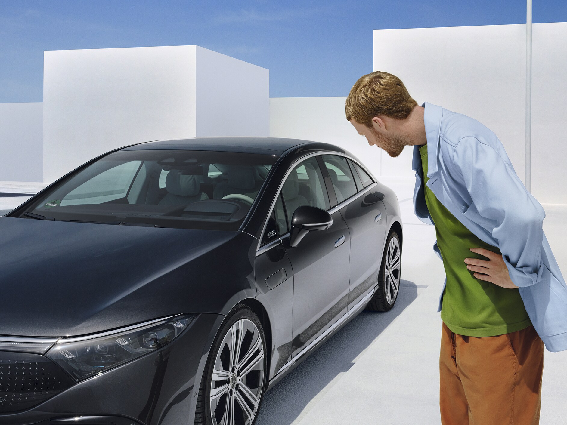 A guy admiring a Mercedes-Benz car