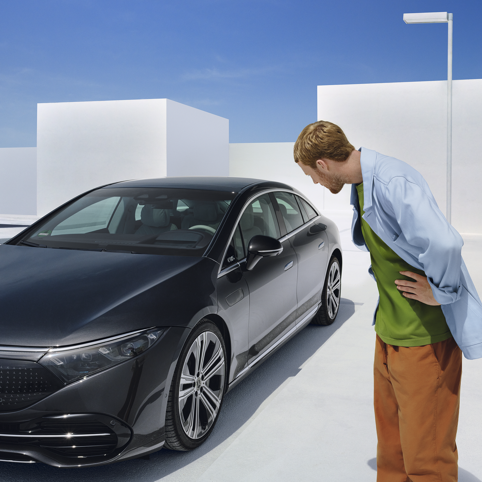 Benefits A guy admiring a Mercedes-Benz car