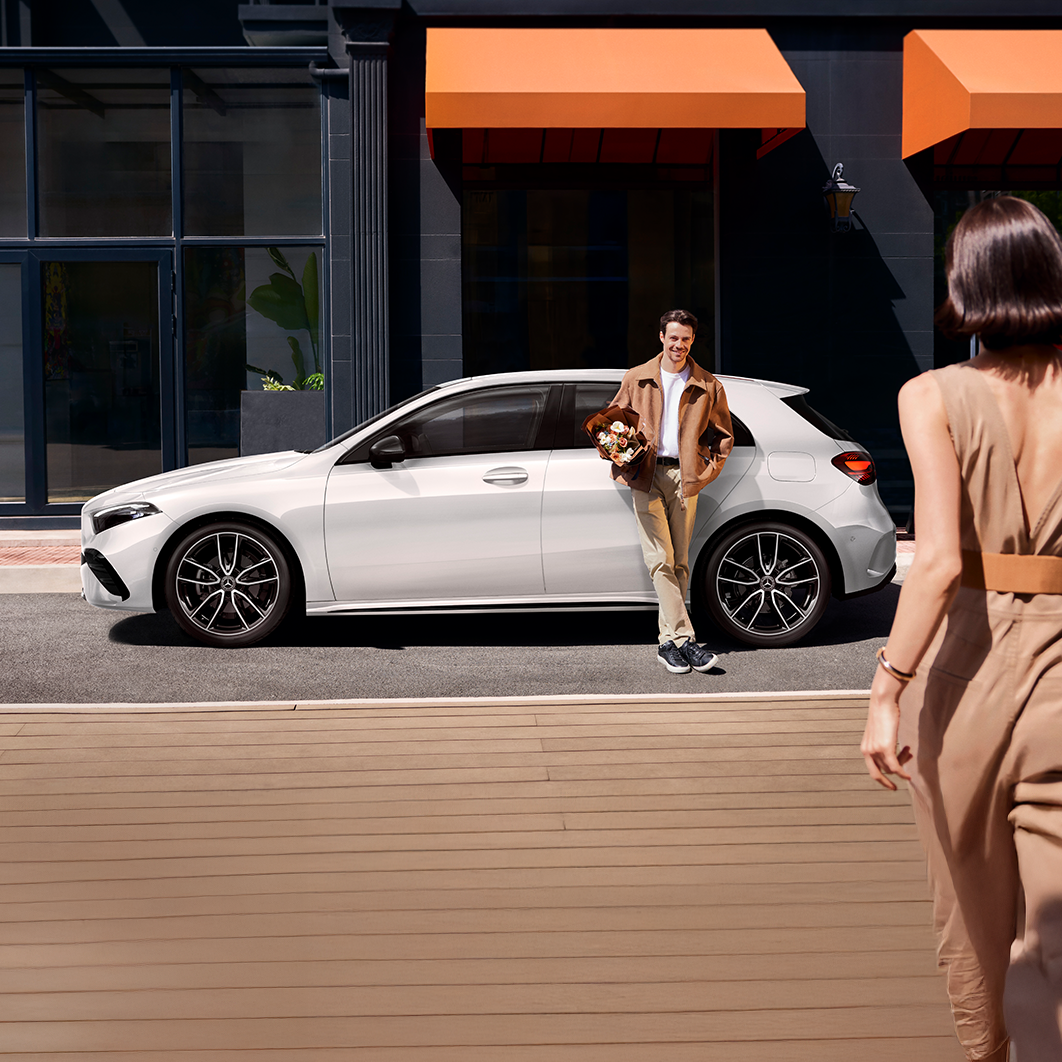 Mercedes-Benz A-Class Hatchback, man with flowers waiting for woman approaching