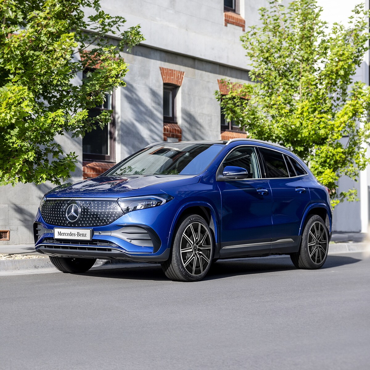 A blue EQA 250+ City Edition parked on the road side