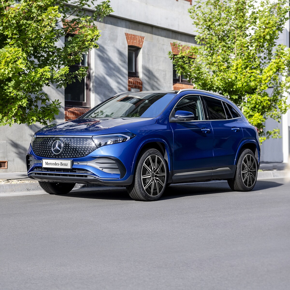 A blue EQA 250+ City Edition parked on the road side