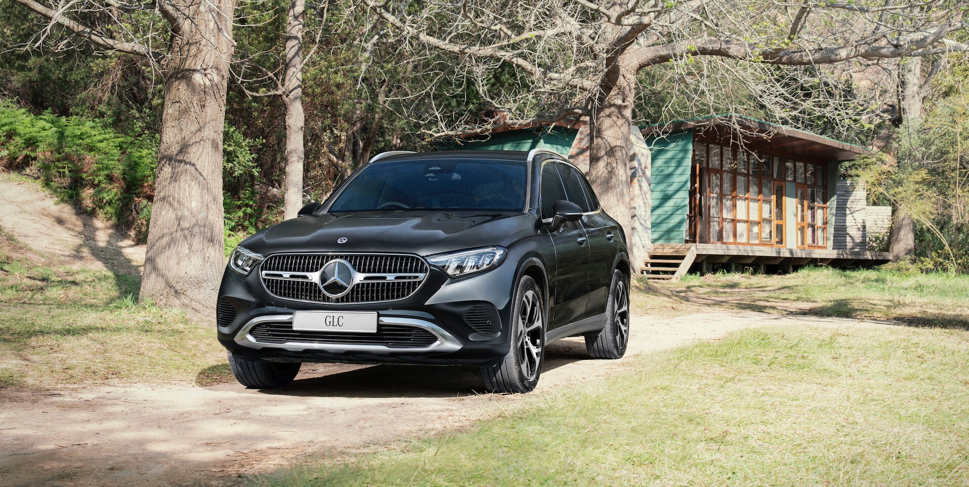 A black car parked on a dirt road