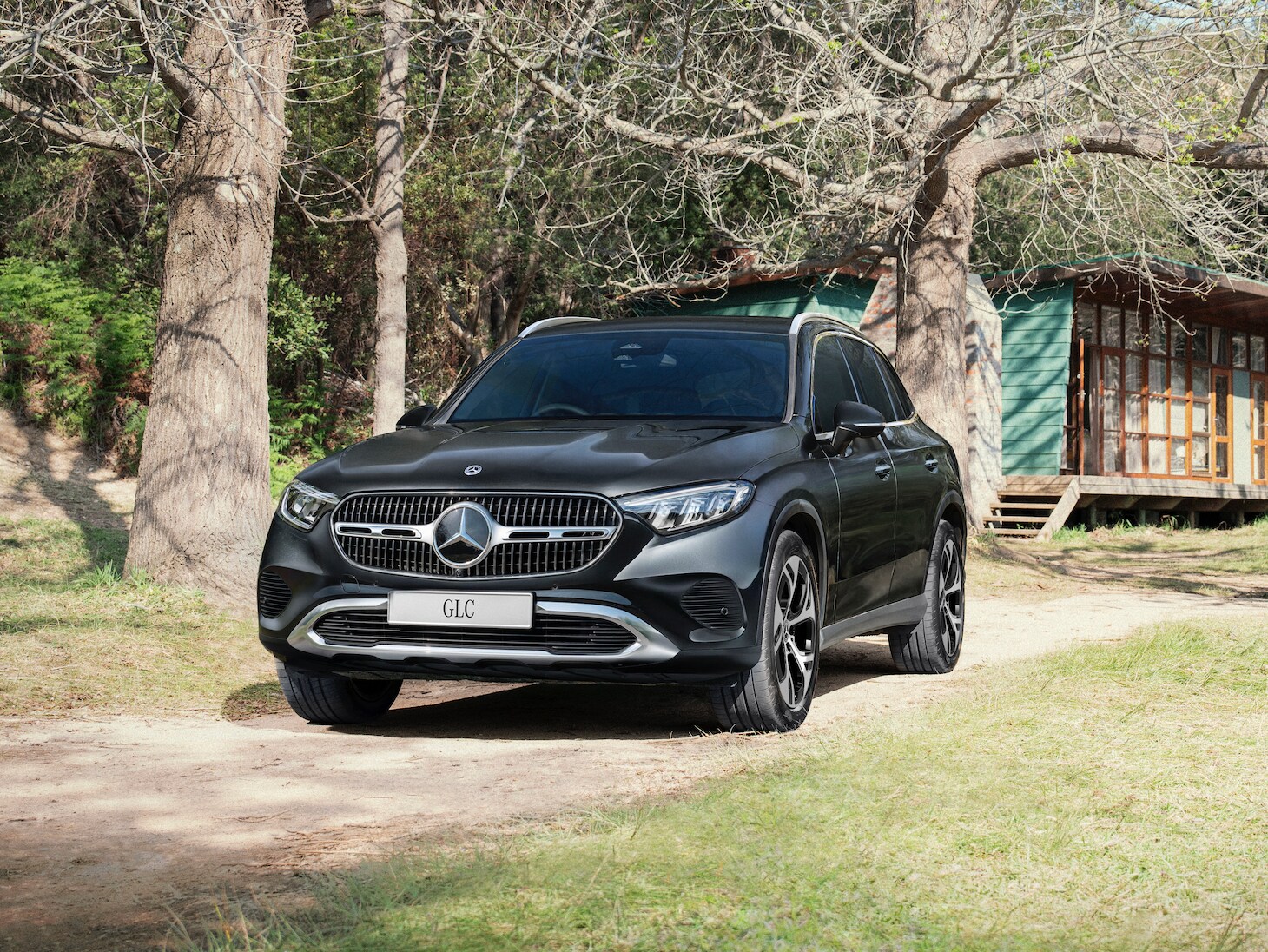 A black car parked on a dirt road
