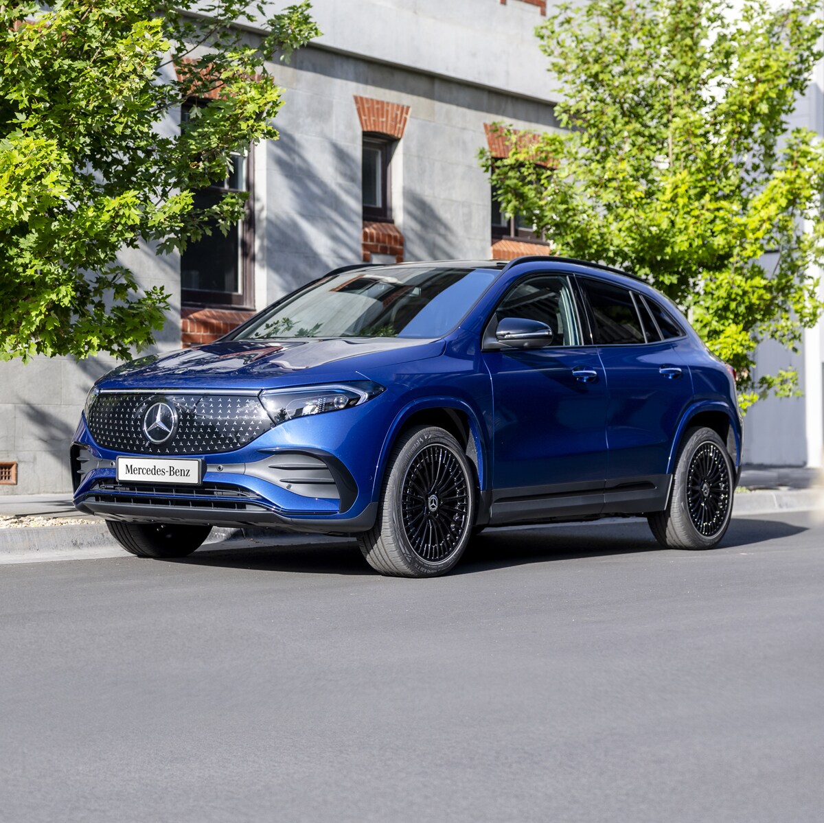 A blue EQA 250+ parked on the road side