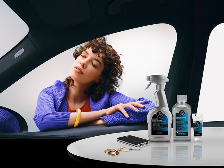 This image shows the a woman and some Mercedes-Benz Store products