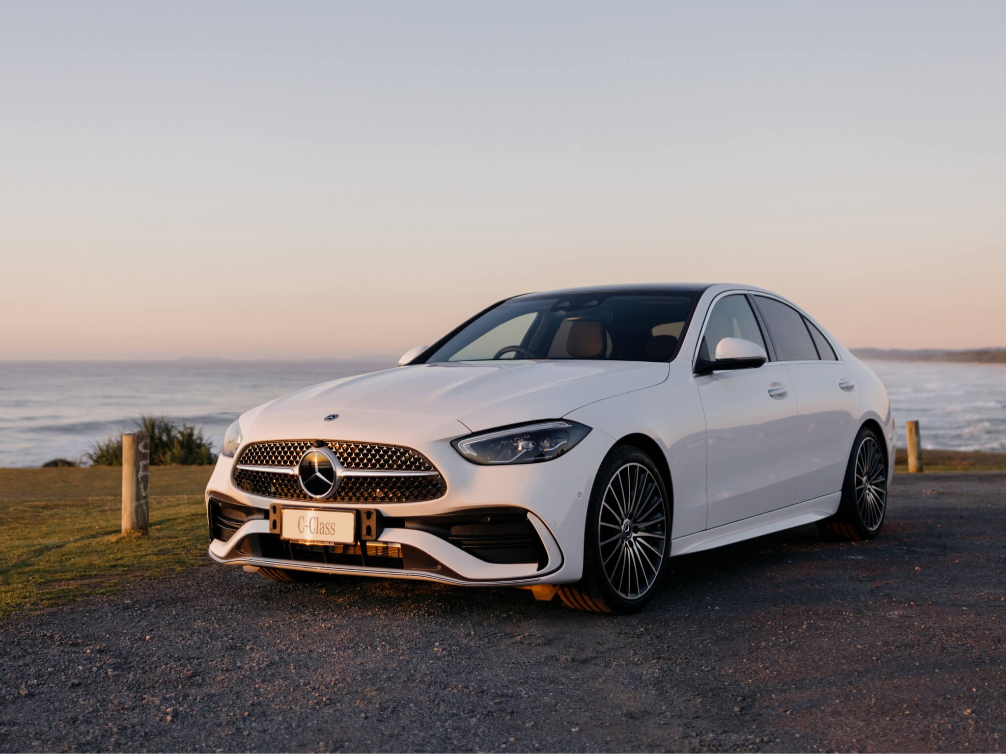 White Mercedes-Benz C 300 parked along the beach coast