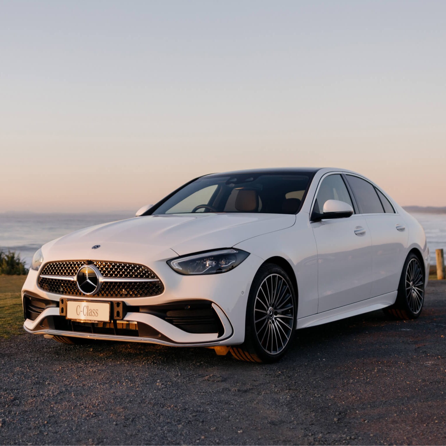 White Mercedes-Benz C 300 parked along the beach coast