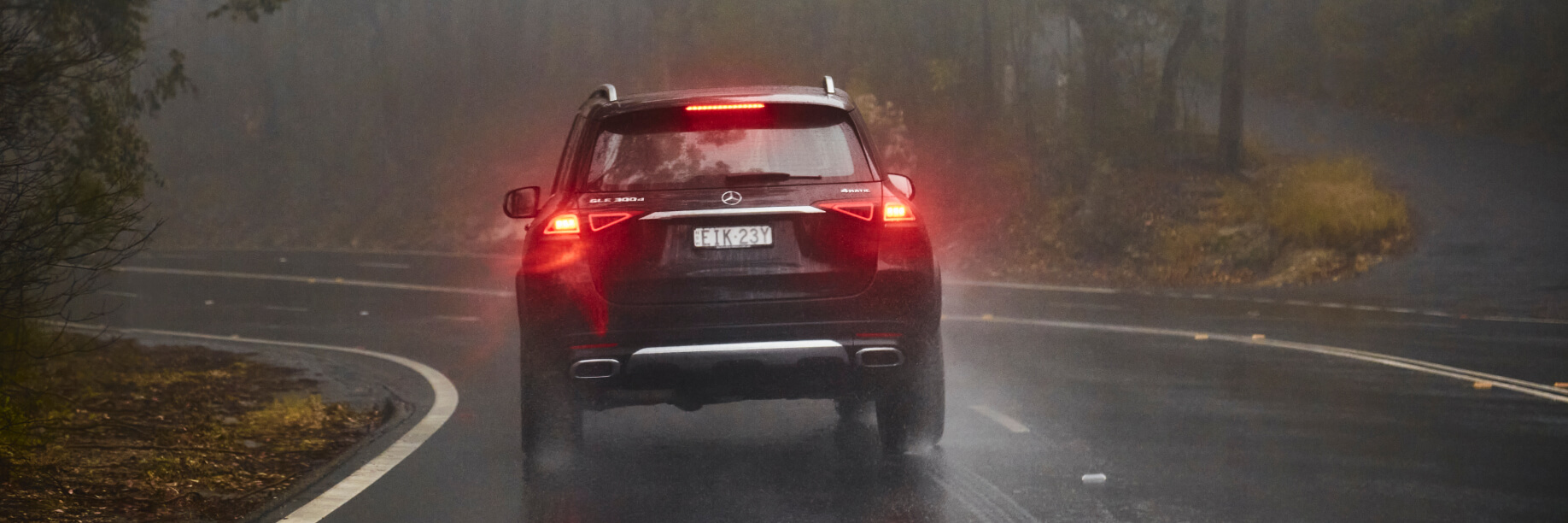 GLE A car drives on a misty road
