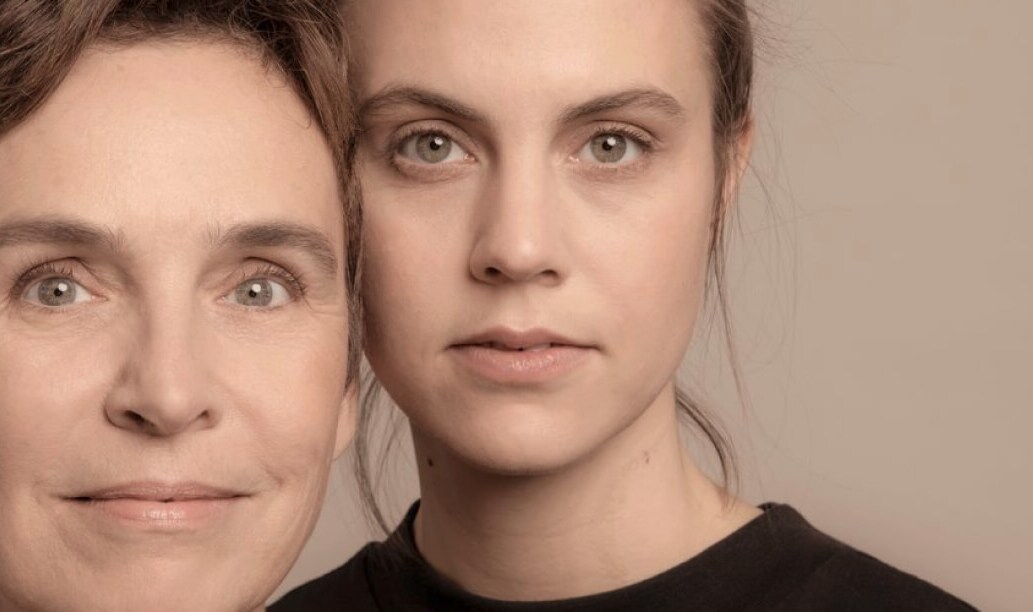 Two women pose for the camera