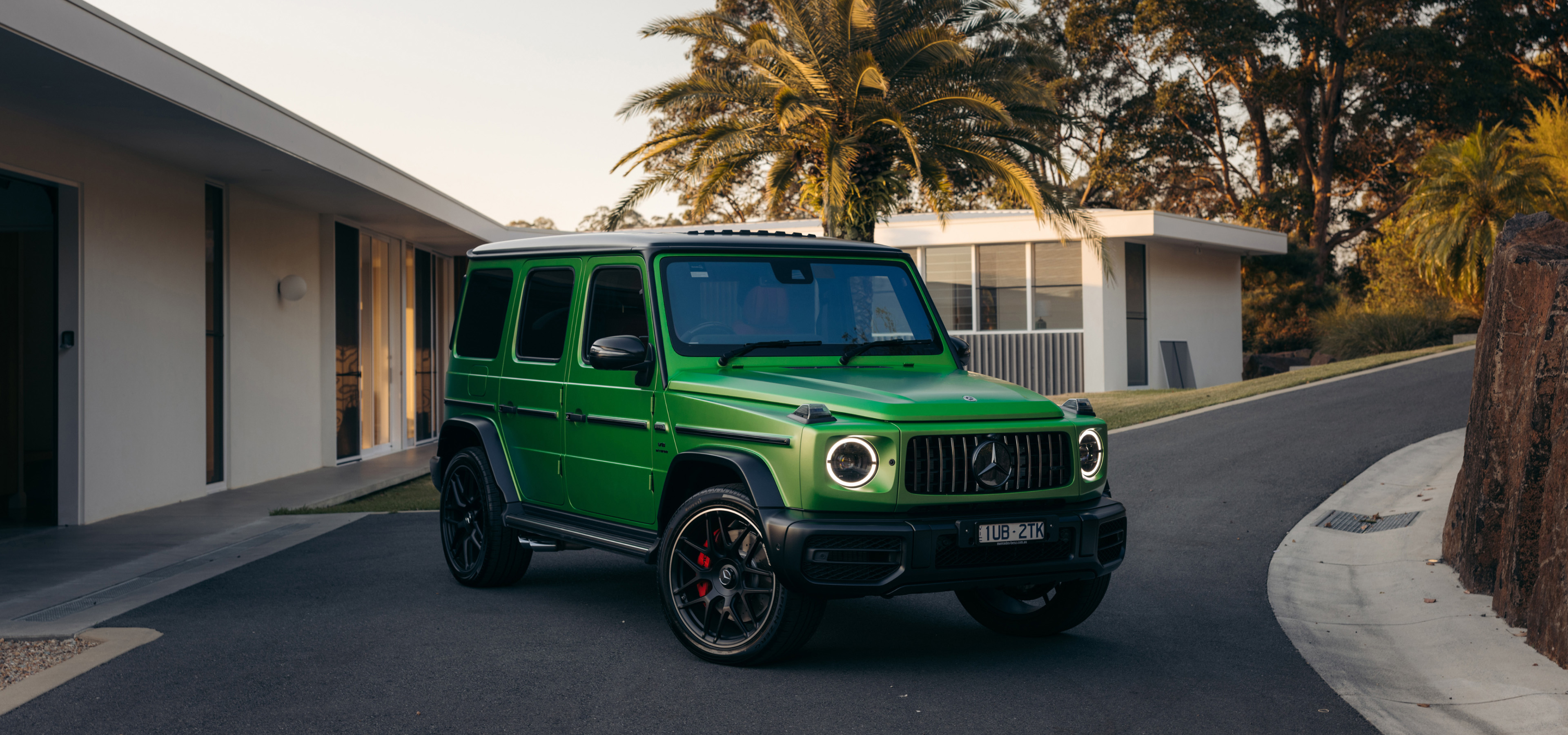 Mercedes-AMG G 63 A green Mercedes-AMG G 63 parked in a driveway.
