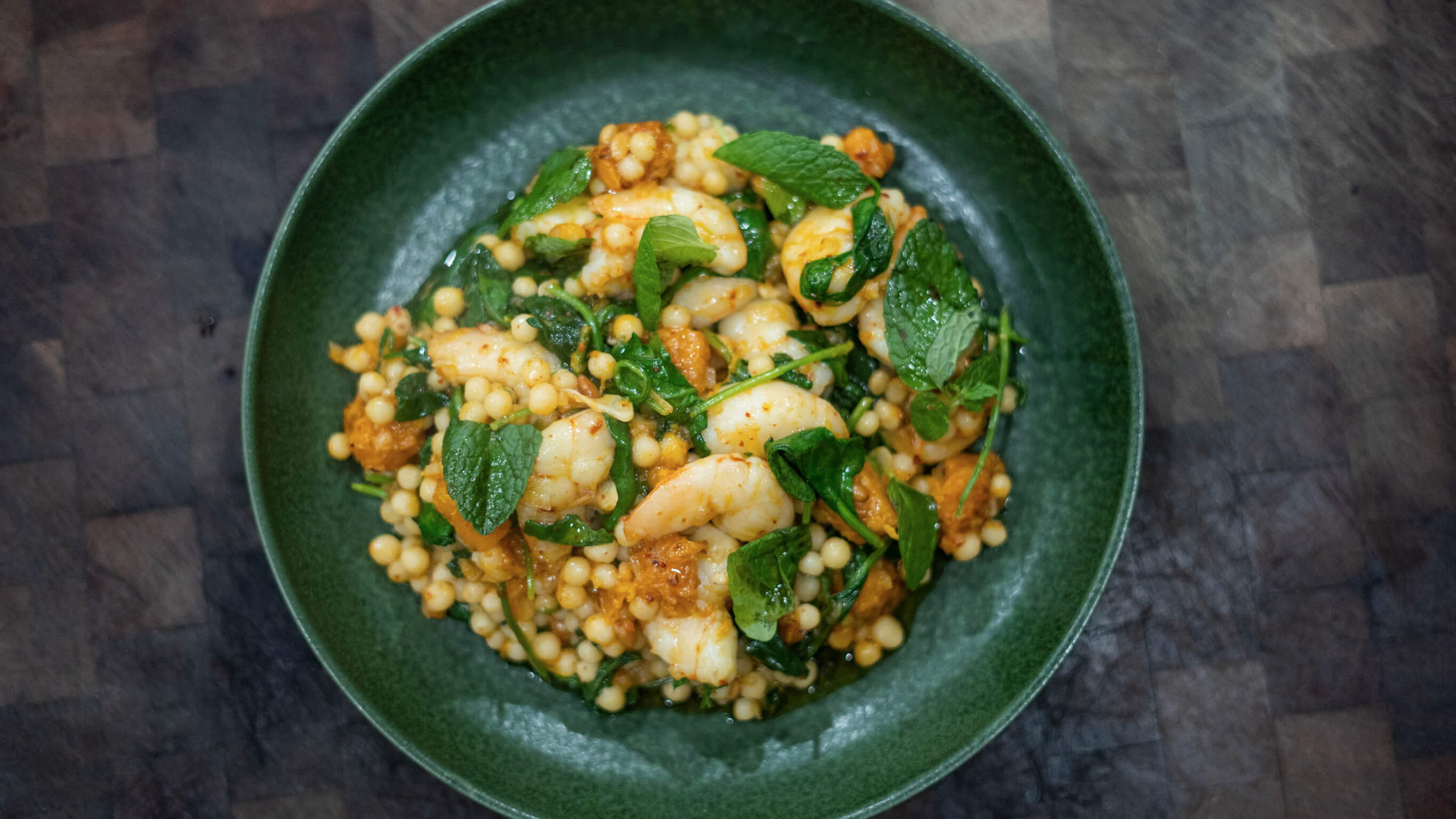 Prawn, Pumpkin & preserved lemon lebansese cous cous with mint & pine nuts Prawns & cous cous ready to be served.