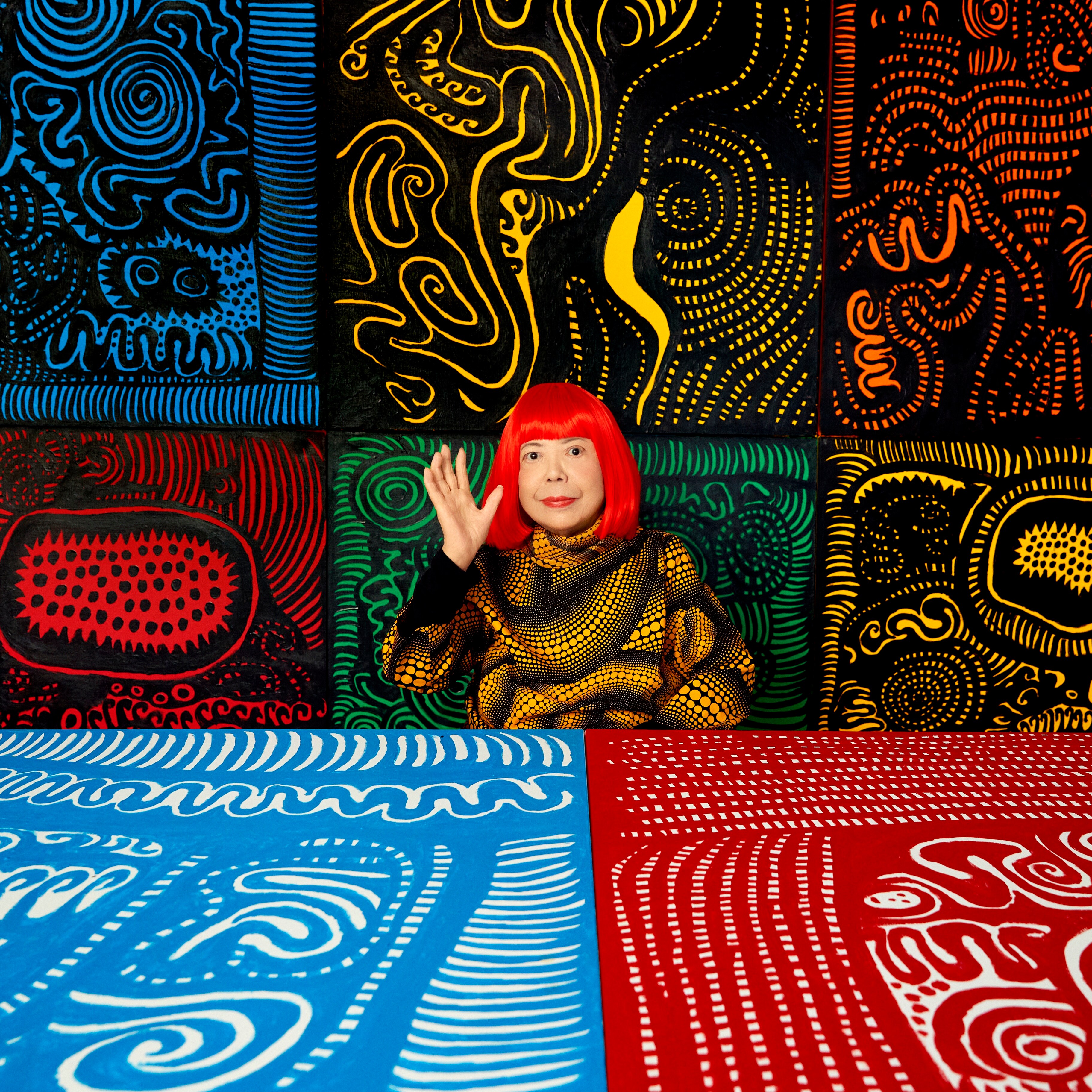 Yayoi Kusama smiling and waving