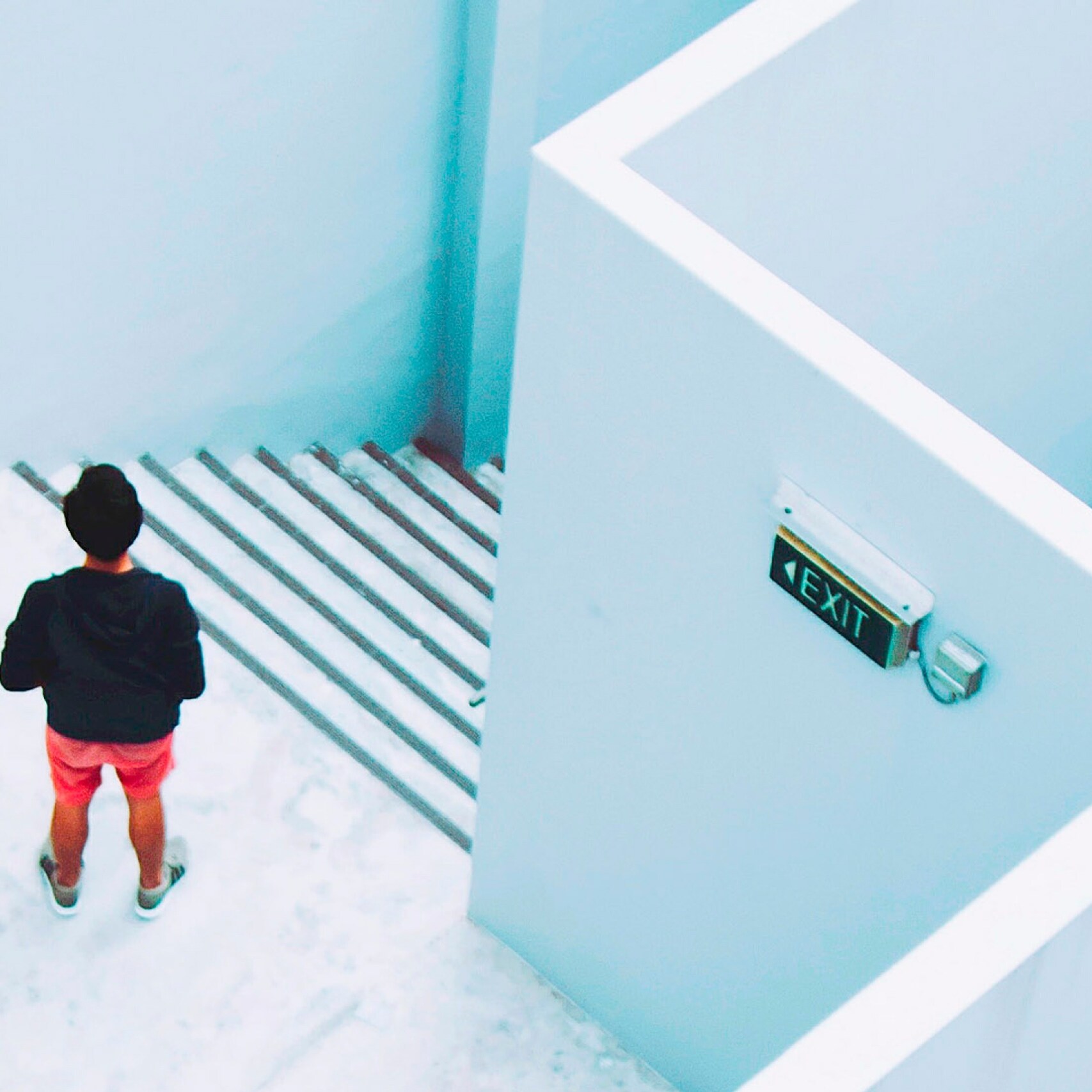 A person standing in a staircase shot from above