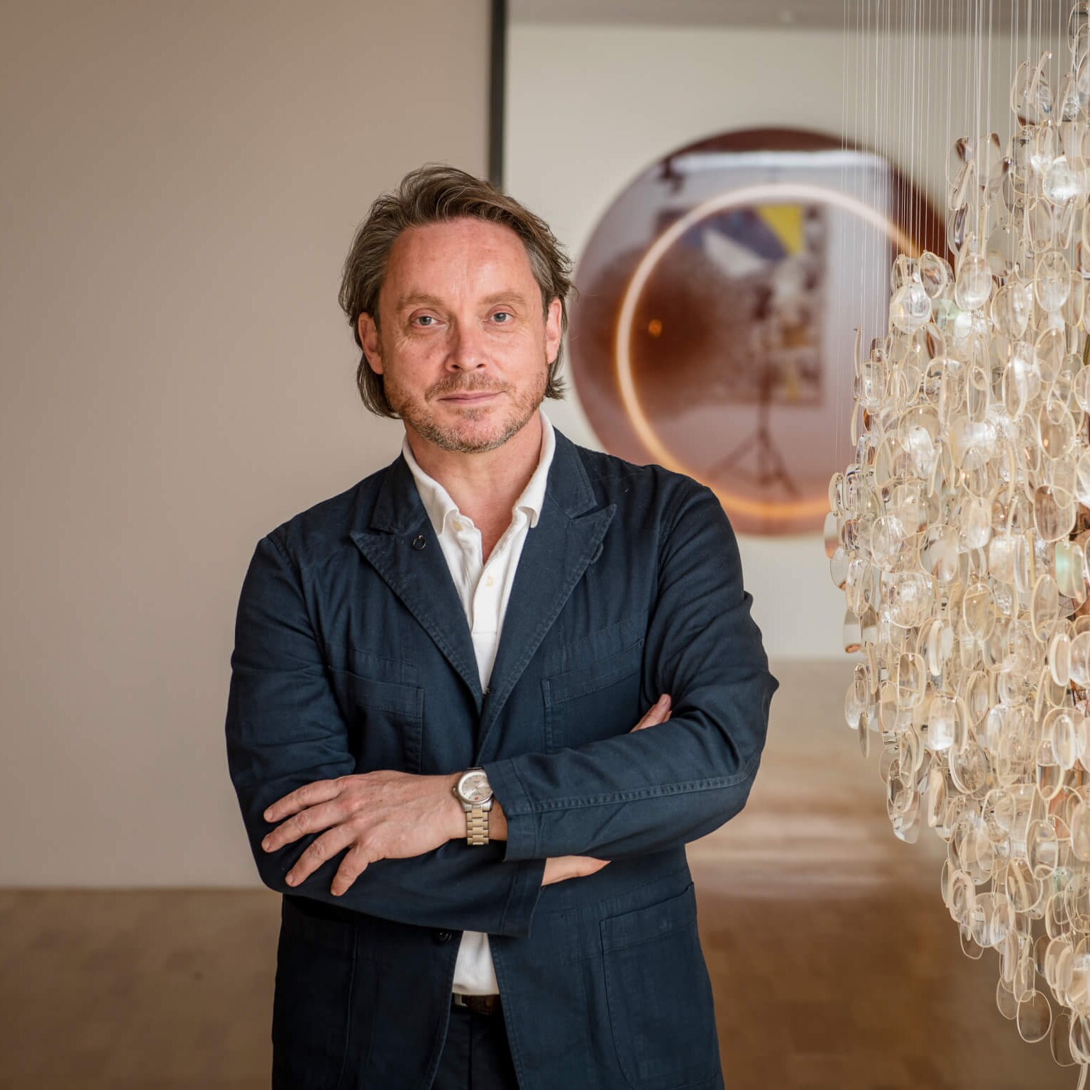 NGV director Tony Ellwood AM next to artwork
