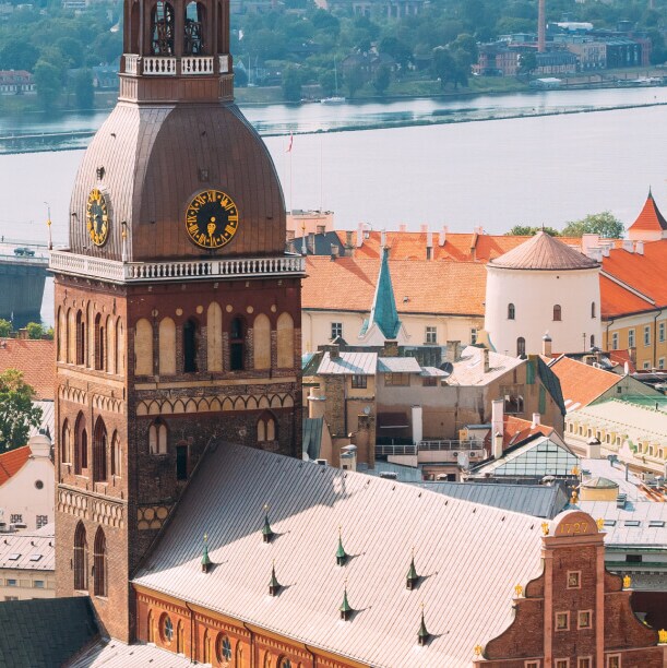 The Riga cityscape beside a river and a long bridge