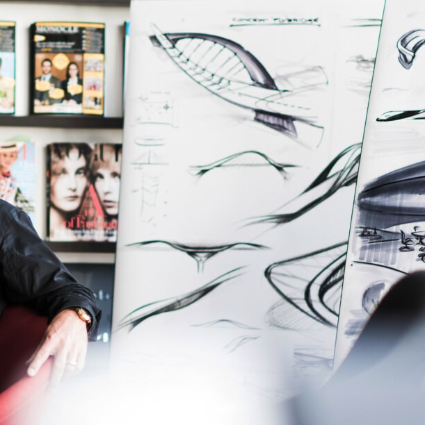 A man smiling and sitting in an office chair