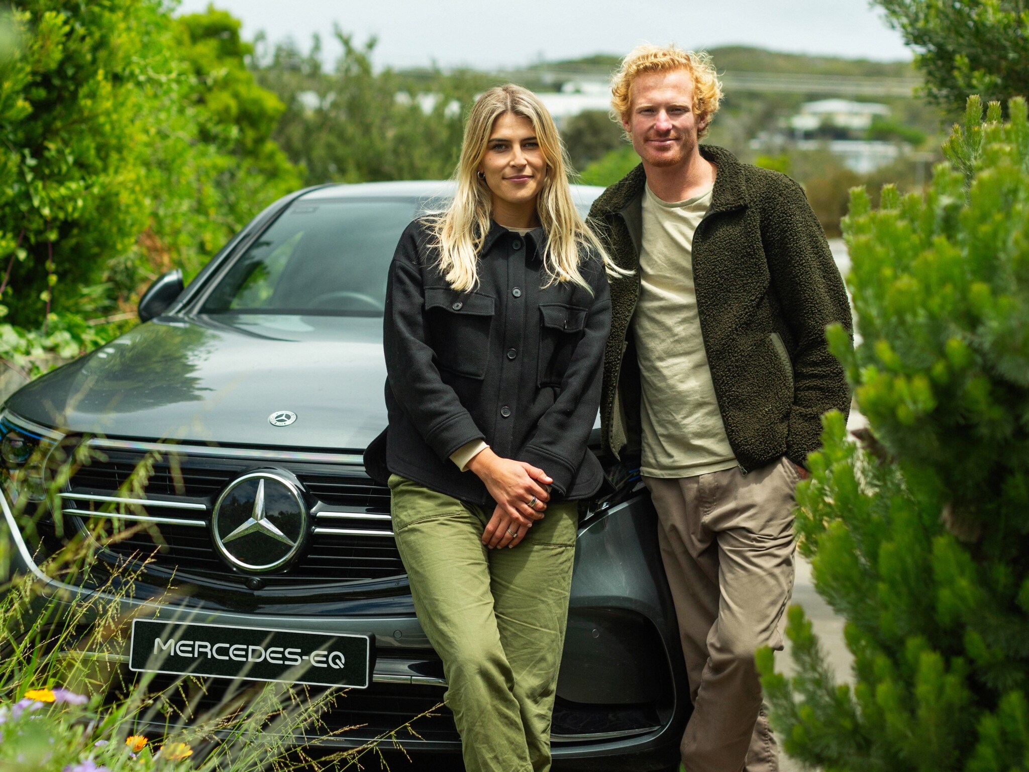 Jordy and Julia Kay smiling beside the EQC.