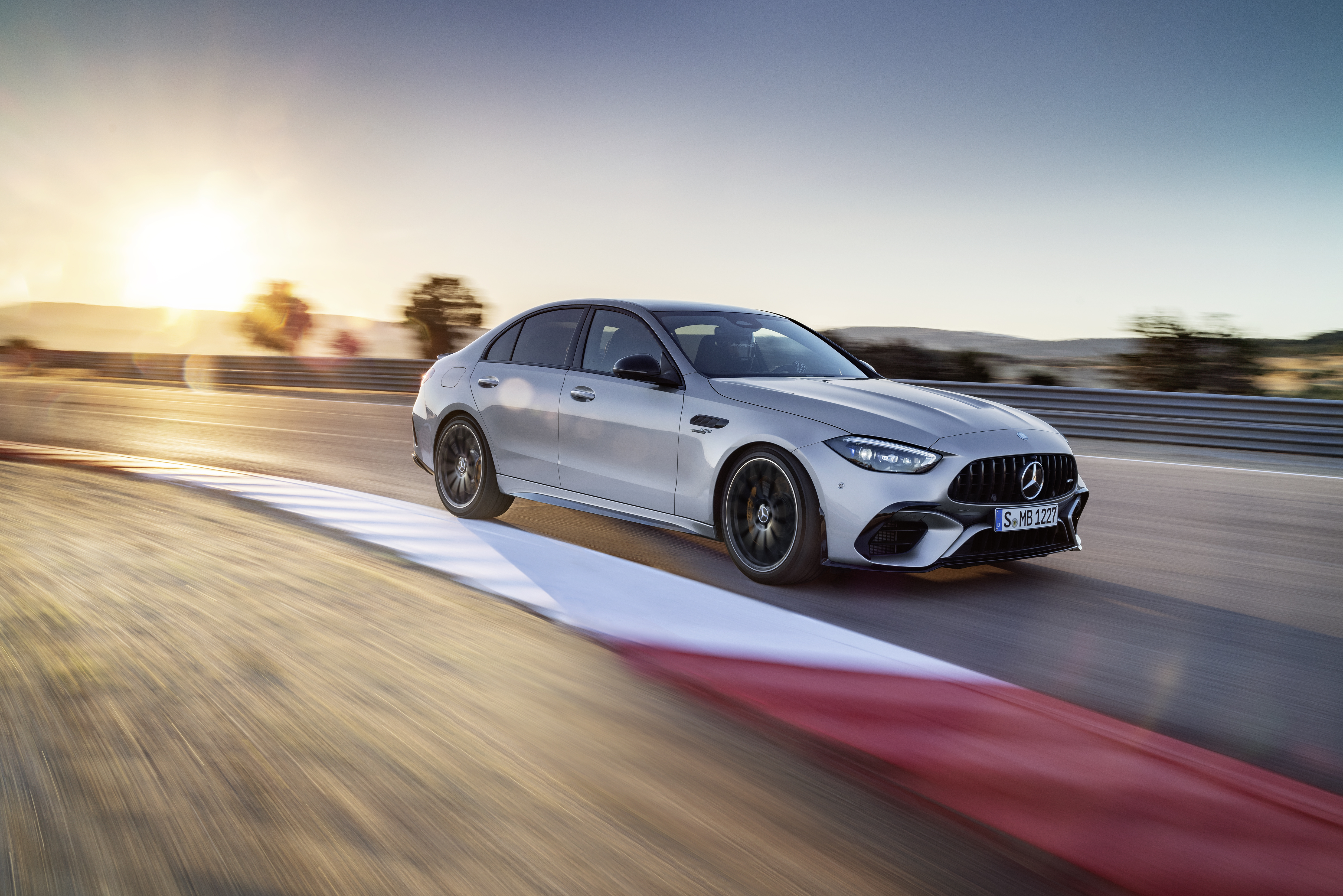 Mercedes-AMG C 63 S E PERFORMANCE driving on a racetrack. Mercedes-AMG C 63 S E PERFORMANCE driving on a racetrack.