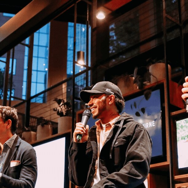 Toto Wolff and Lewis Hamilton on stage with Tom Clarkson
