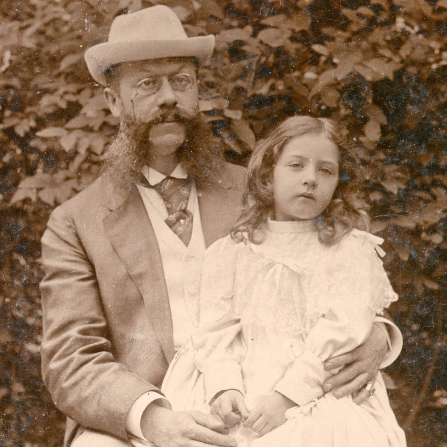 An old sepia photograph of a man with his daughter