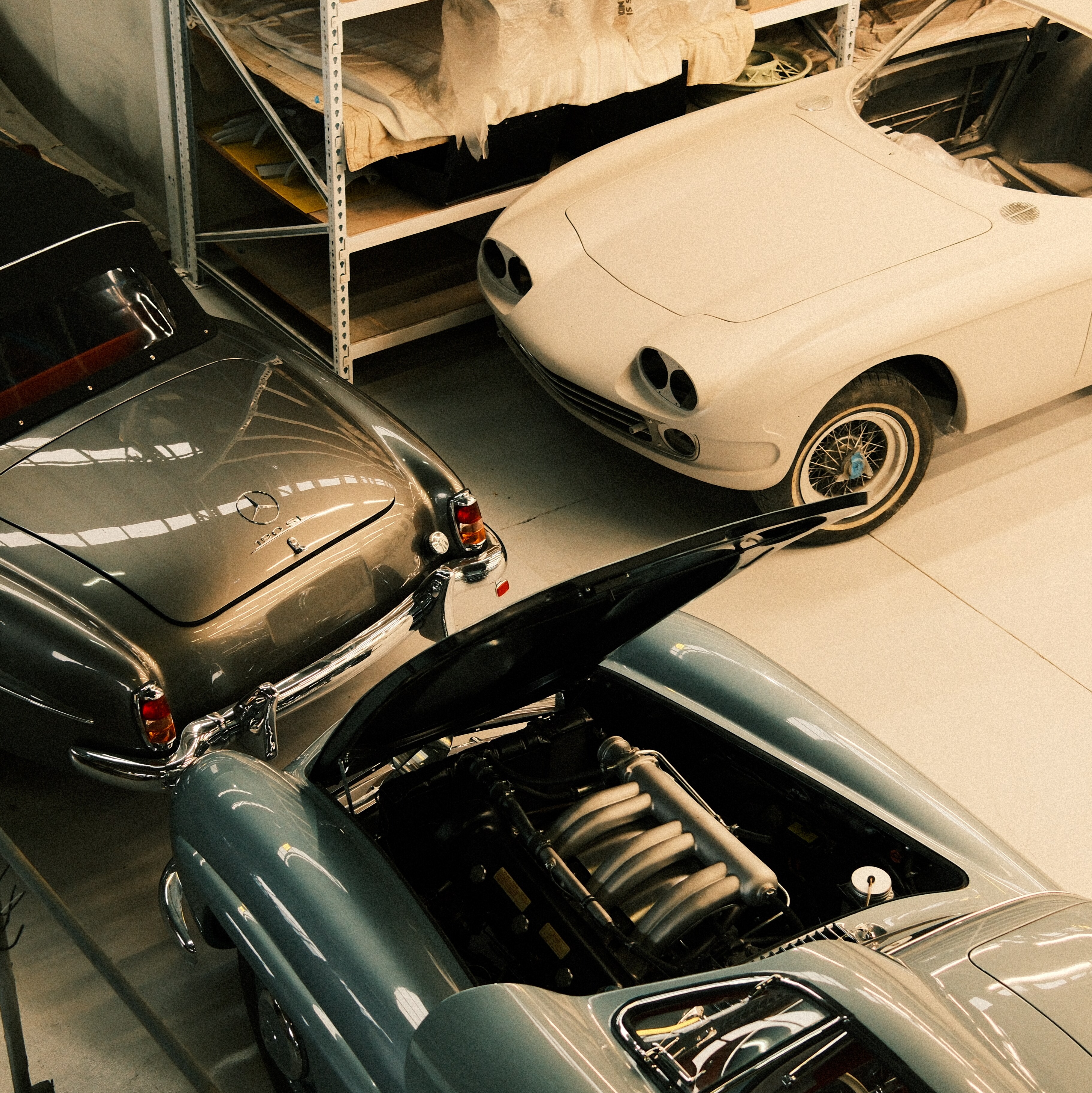 Three classic Mercedes-Benz cars at the Sleeping Beauties workshop in Brisbane.