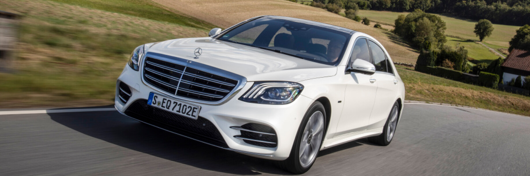 New S-Class A white car drives on a road