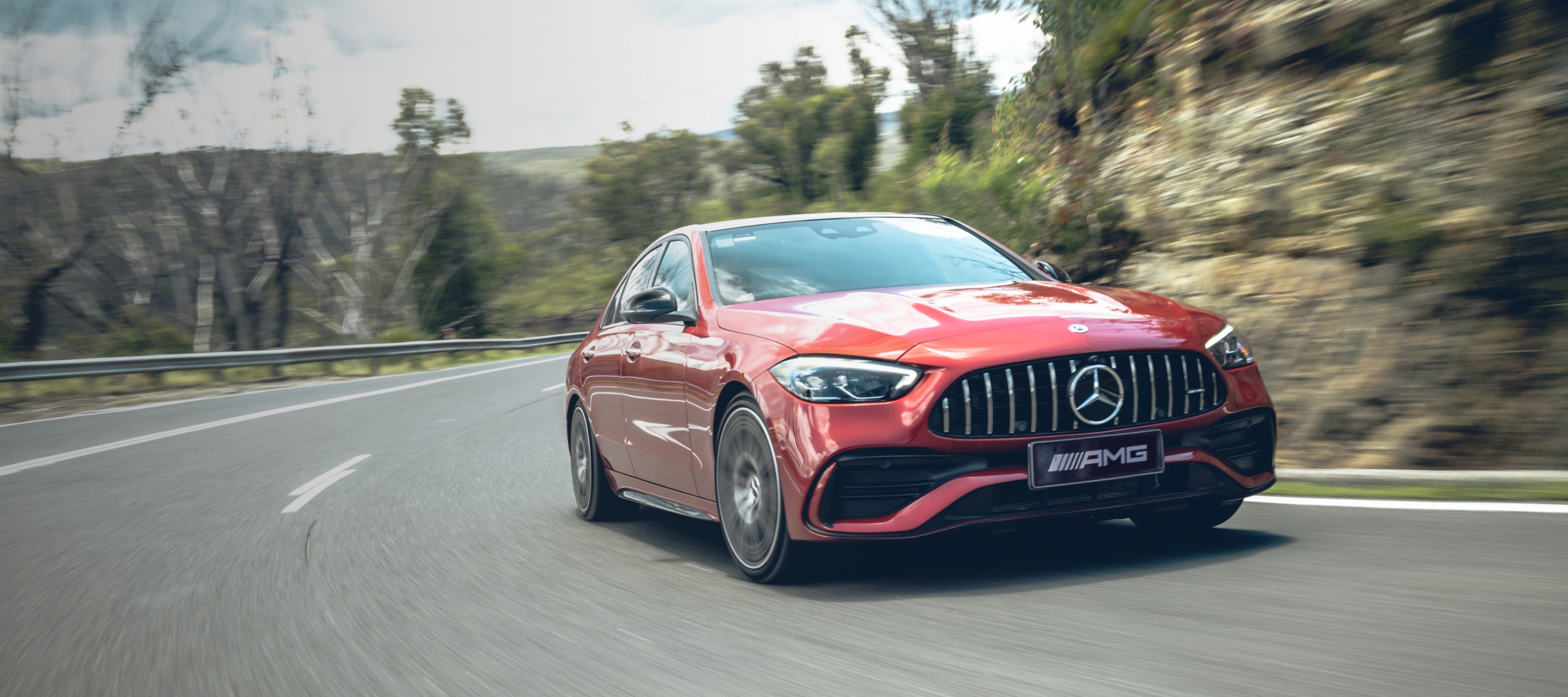 Mercedes-AMG C 43 A red Mercedes-AMG C 43 driving round a bend in the road.