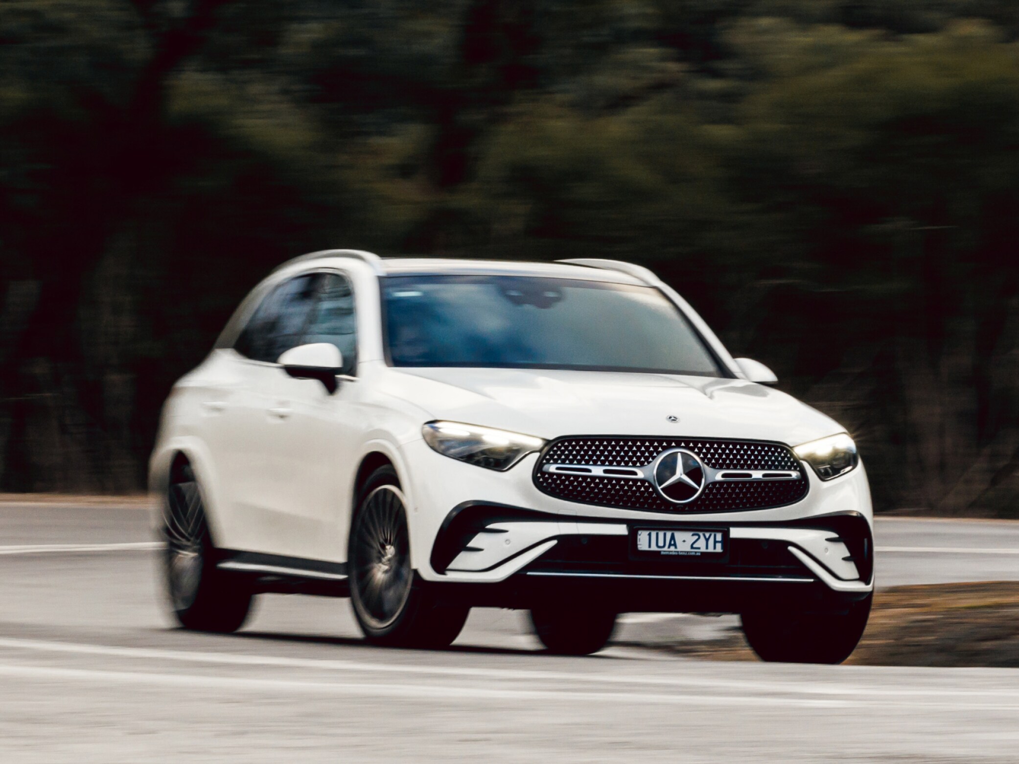 A white Mercedes-Benz GLC 300 4MATIC driving on a country road. Image credit/photographer: Stephen Dwight