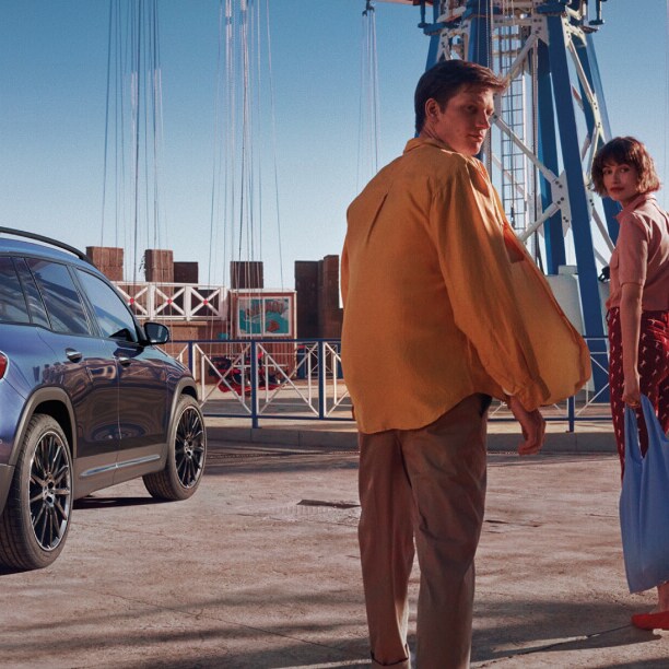 A family walking towards a Mercedes-Benz GLB