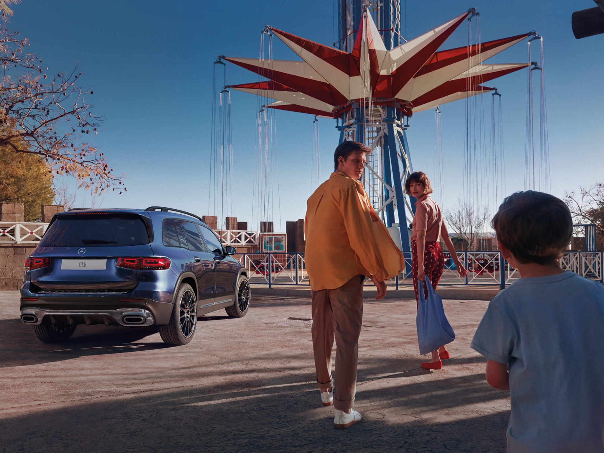 A family walking towards a Mercedes-Benz GLB