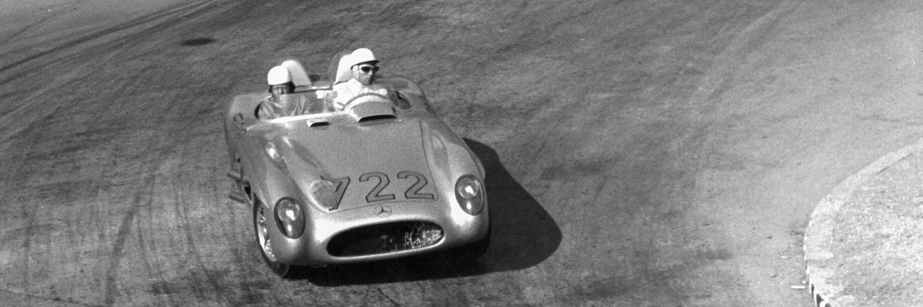 1955 Mille Miglia A black and white photo of two men in a Mercedes-Benz 300 SLR in 1955
