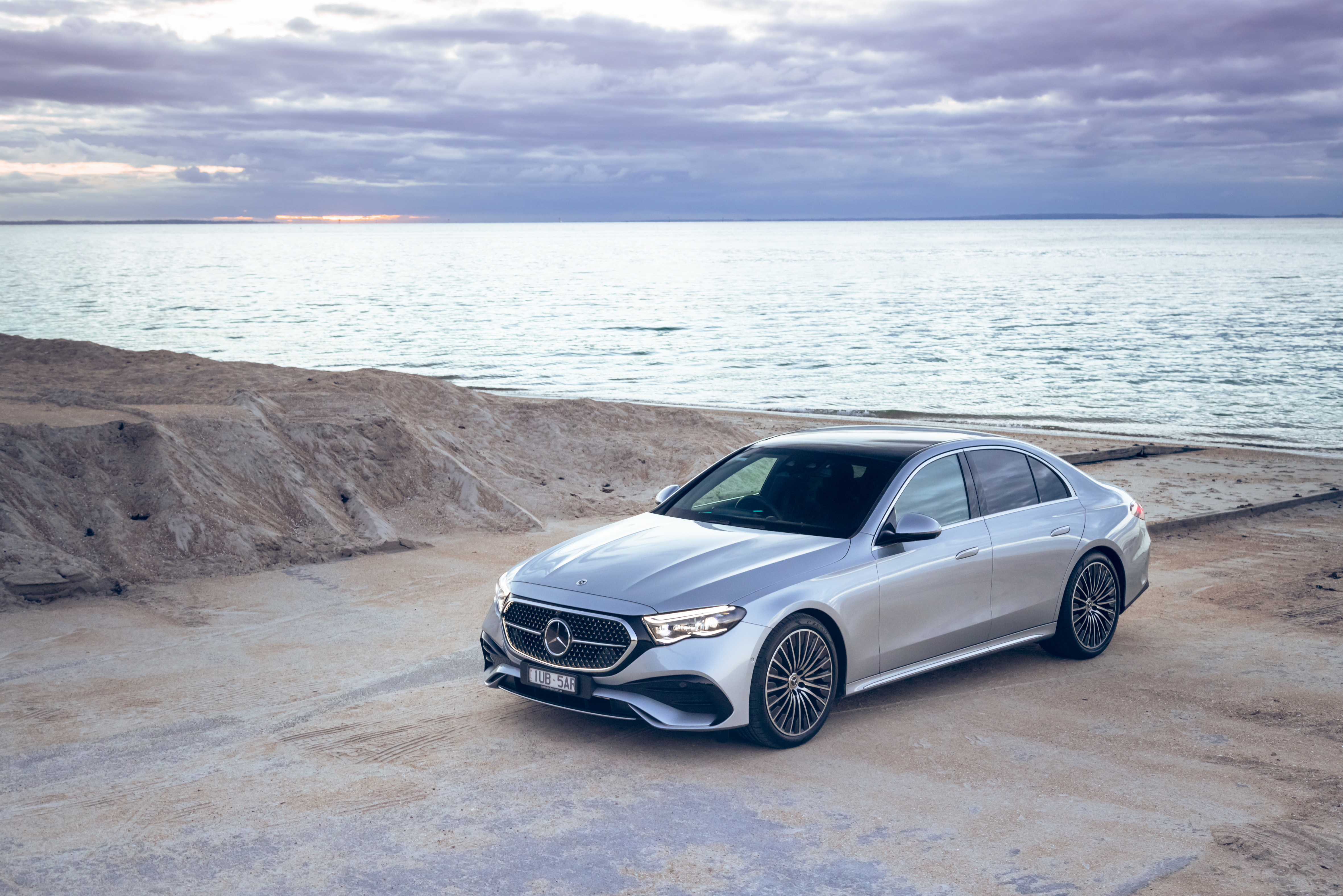 Mercedes-Benz E-Class A silver Mercedes-Benz E-Class parked by a beach