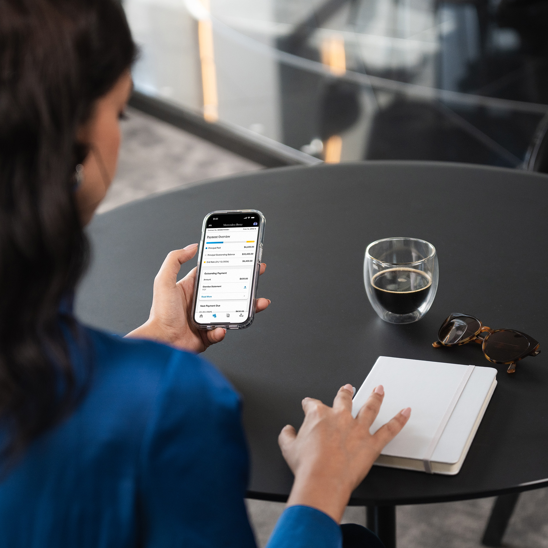 Financial assistance for Mercedes-Benz customers. A person on their phone using the Mercedes-Benz Finance App.
