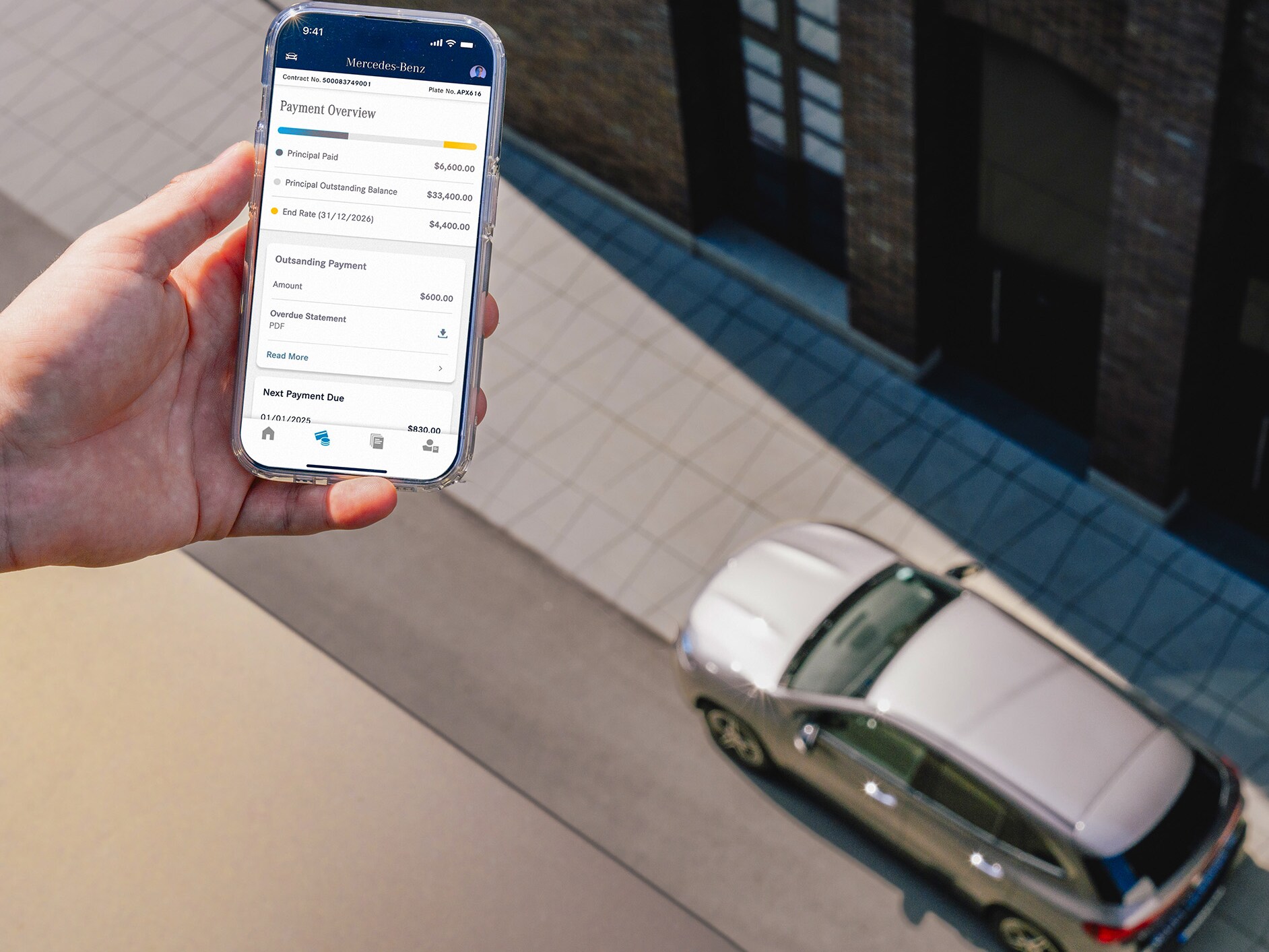 A hand holding a smartphone with a Mercedes-Benz car in the background