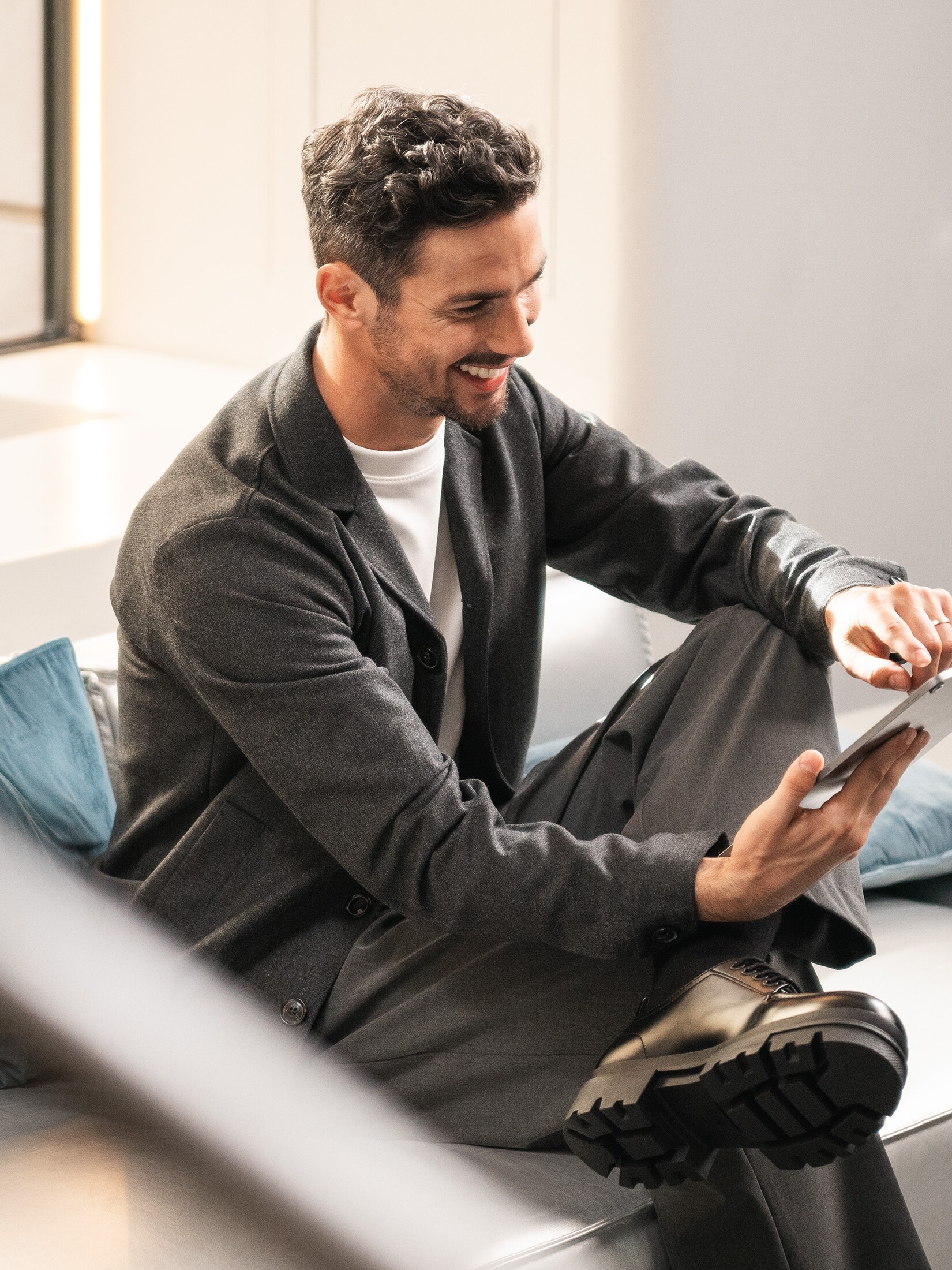 Person on couch using tablet.