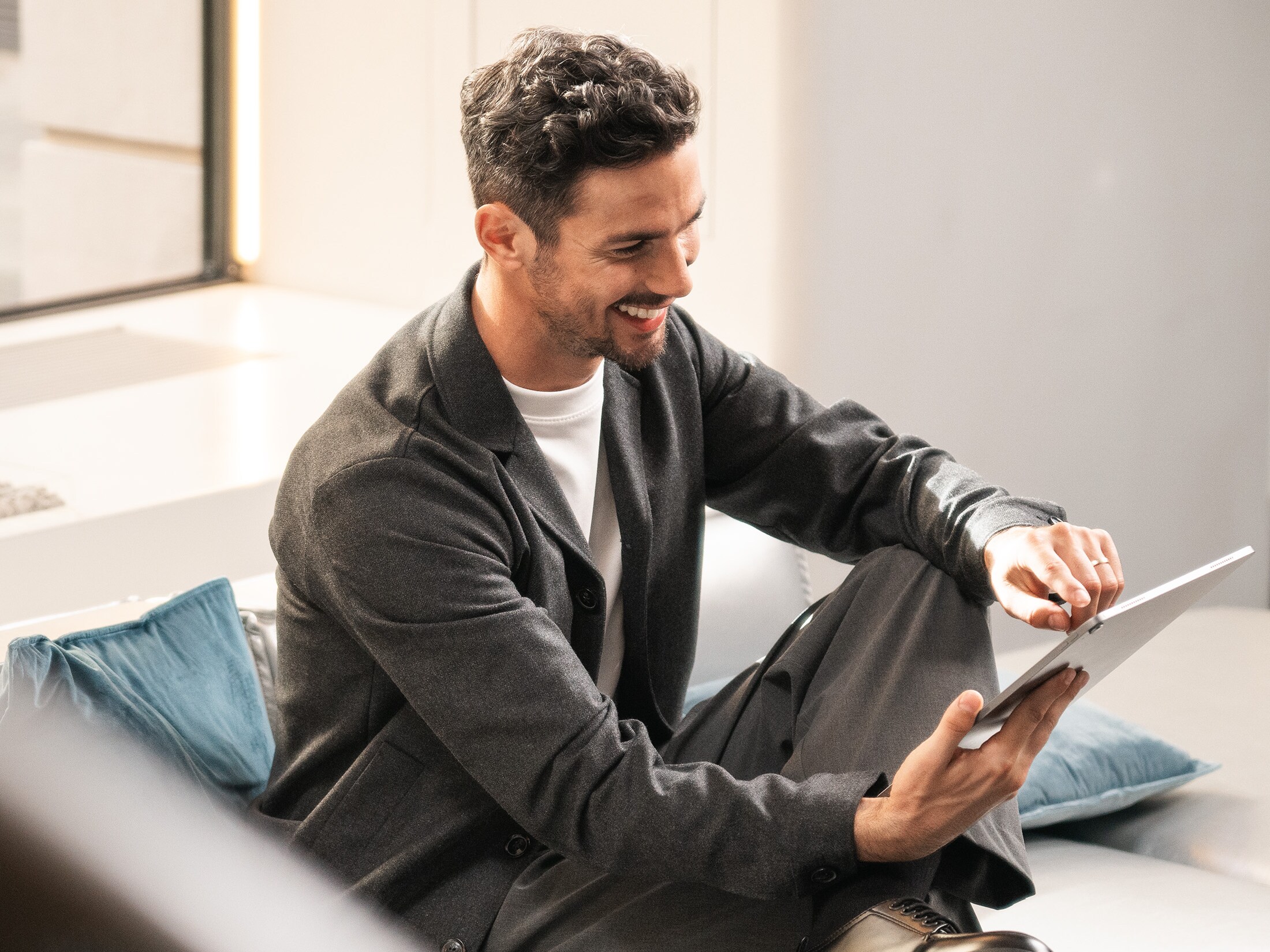 Person on couch using tablet.