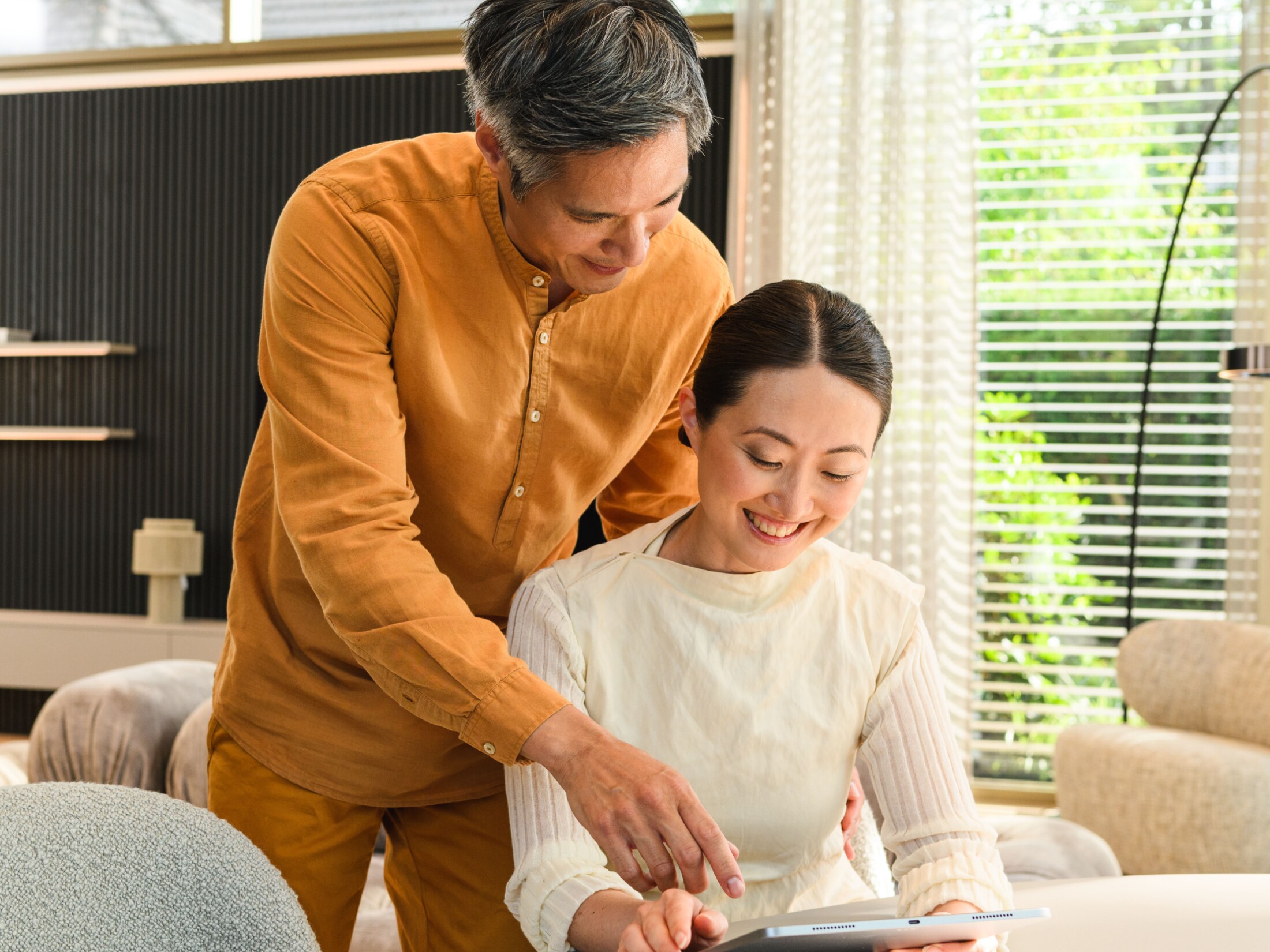 A couple looking at a tablet