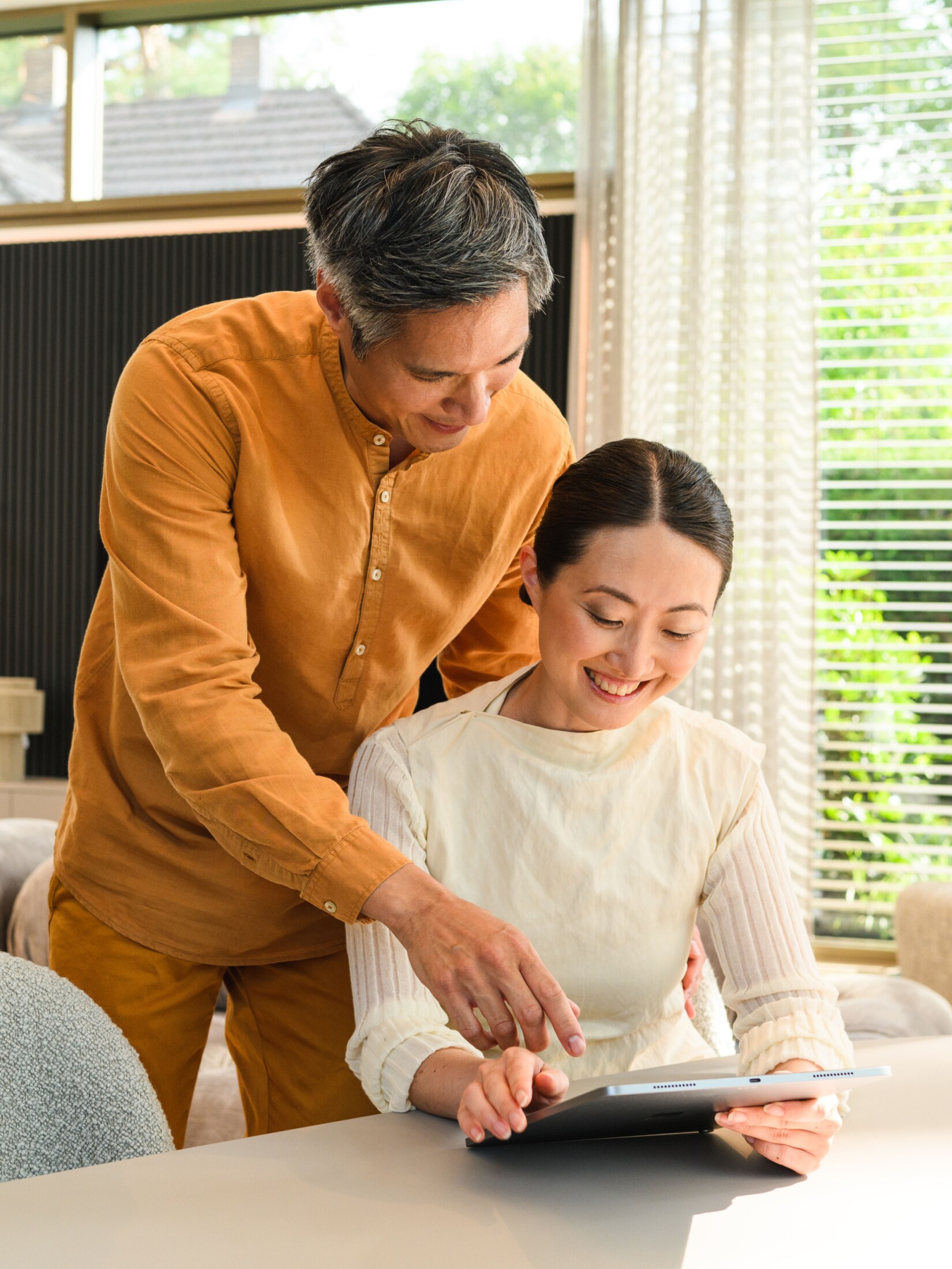 A couple looking at a tablet