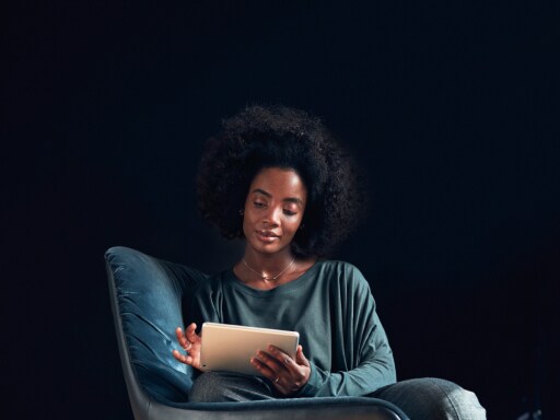 The image shows a woman using a tablet device.