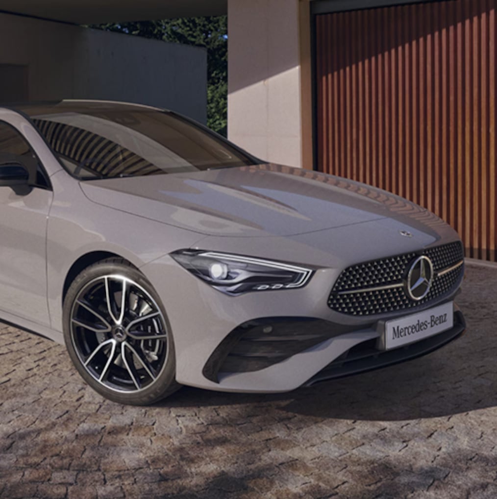 View of a Mercedes-Benz CLA 250 e Coupé with EQ hybrid technology standing at a charging station.
