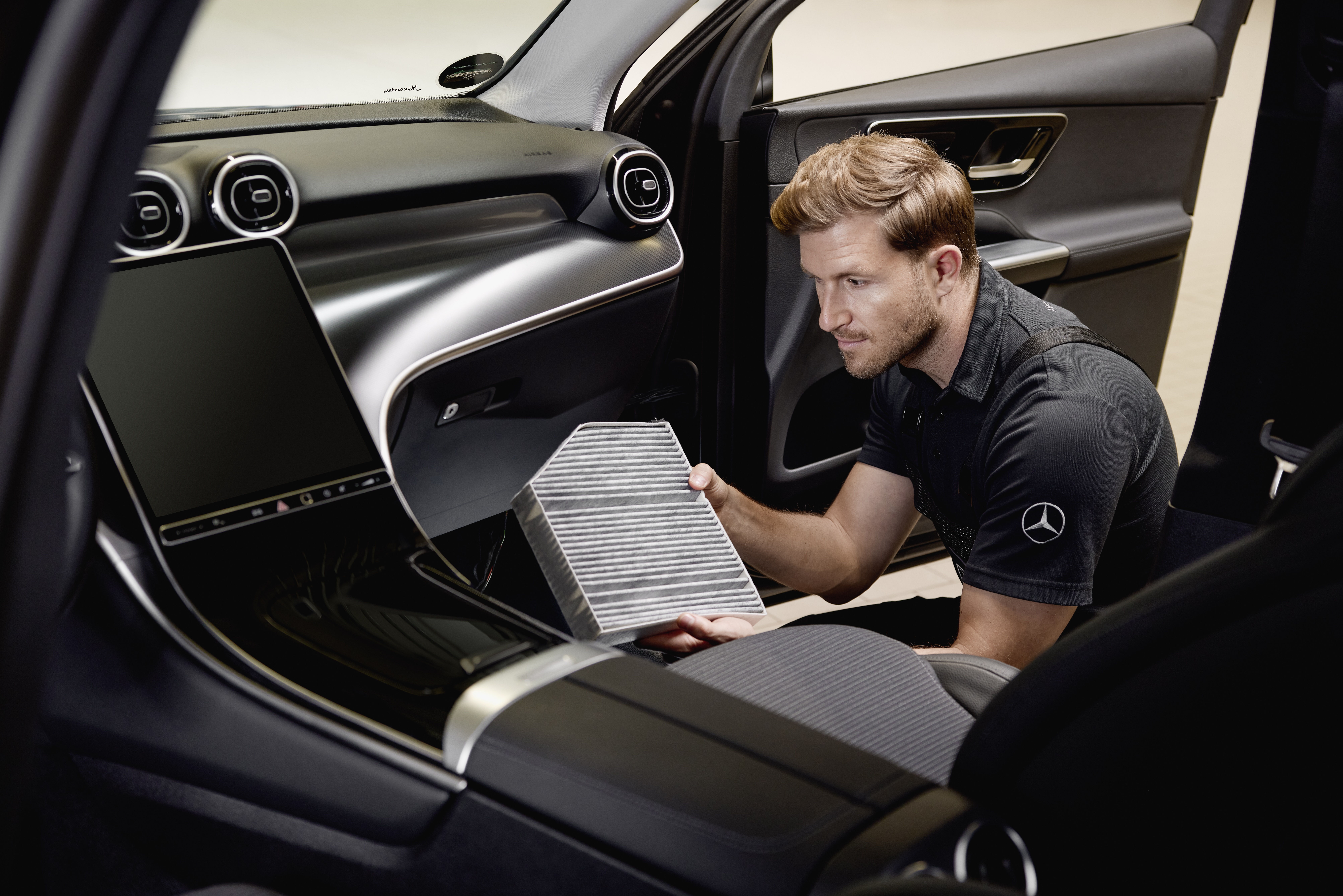 Mercedes-Benz Genuine Cabin Air Filters Interior service operation showing the replacement of a cabin air filter using a genuine Mercedes‑Benz part.