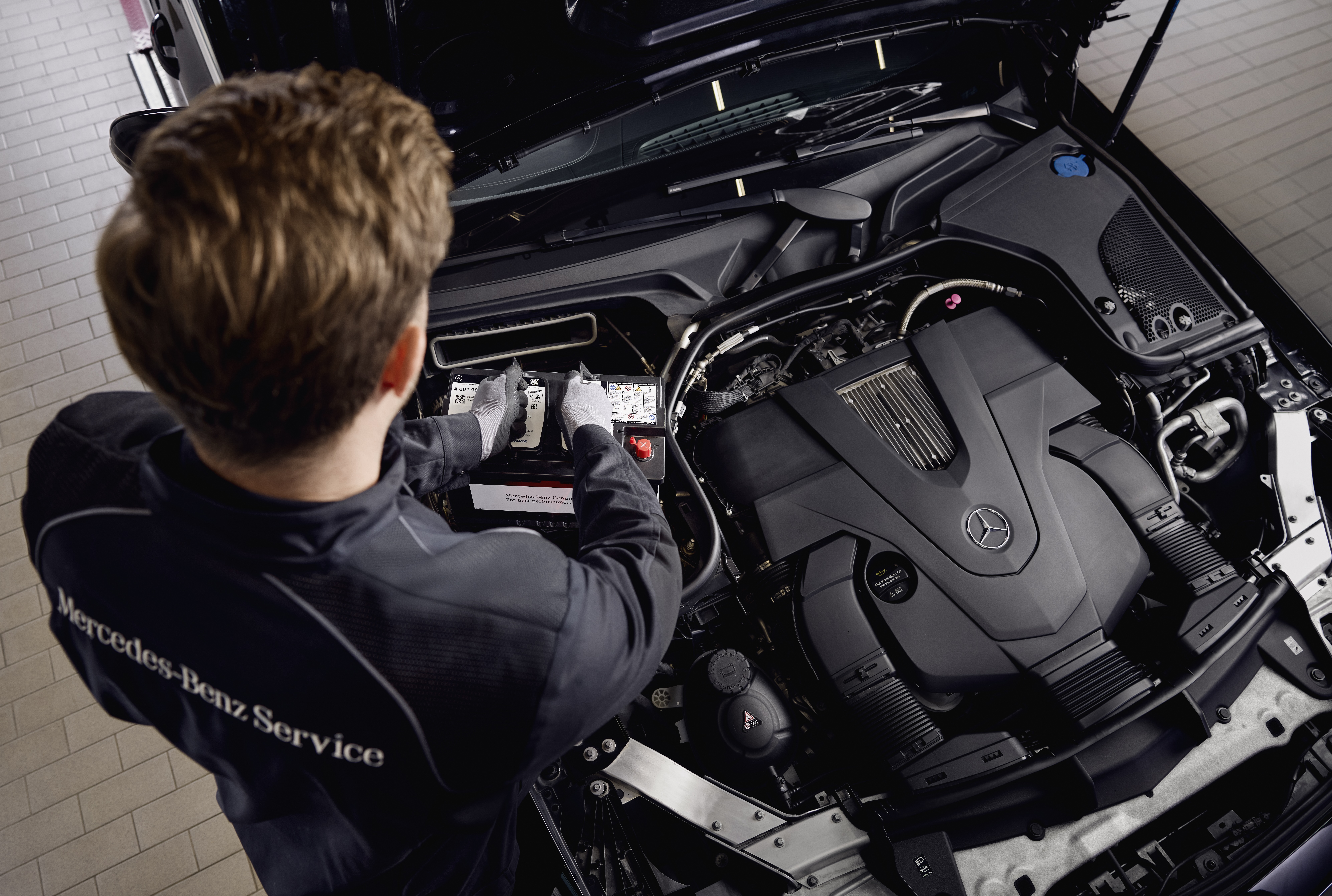 Mercedes-Benz Genuine Starter Batteries Engine service at a workshop, showing the replacement of components using genuine Mercedes‑Benz parts.