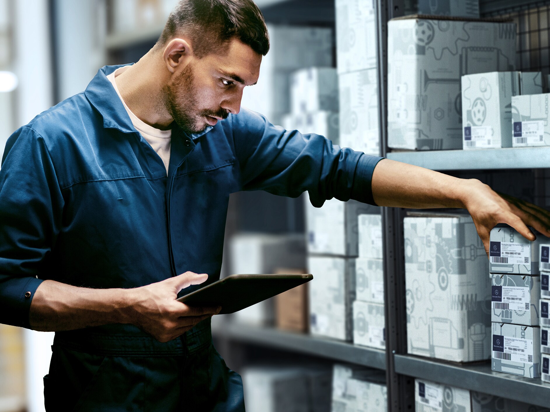 I man checking stock in a warehouse