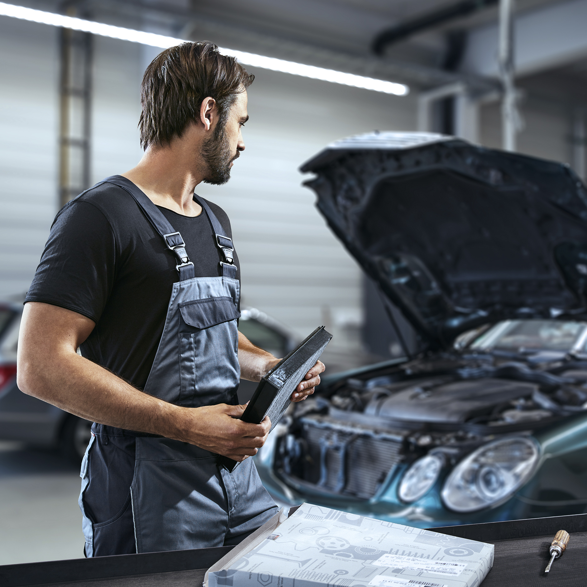 Mechanic checking a car Mechanic checking a car
