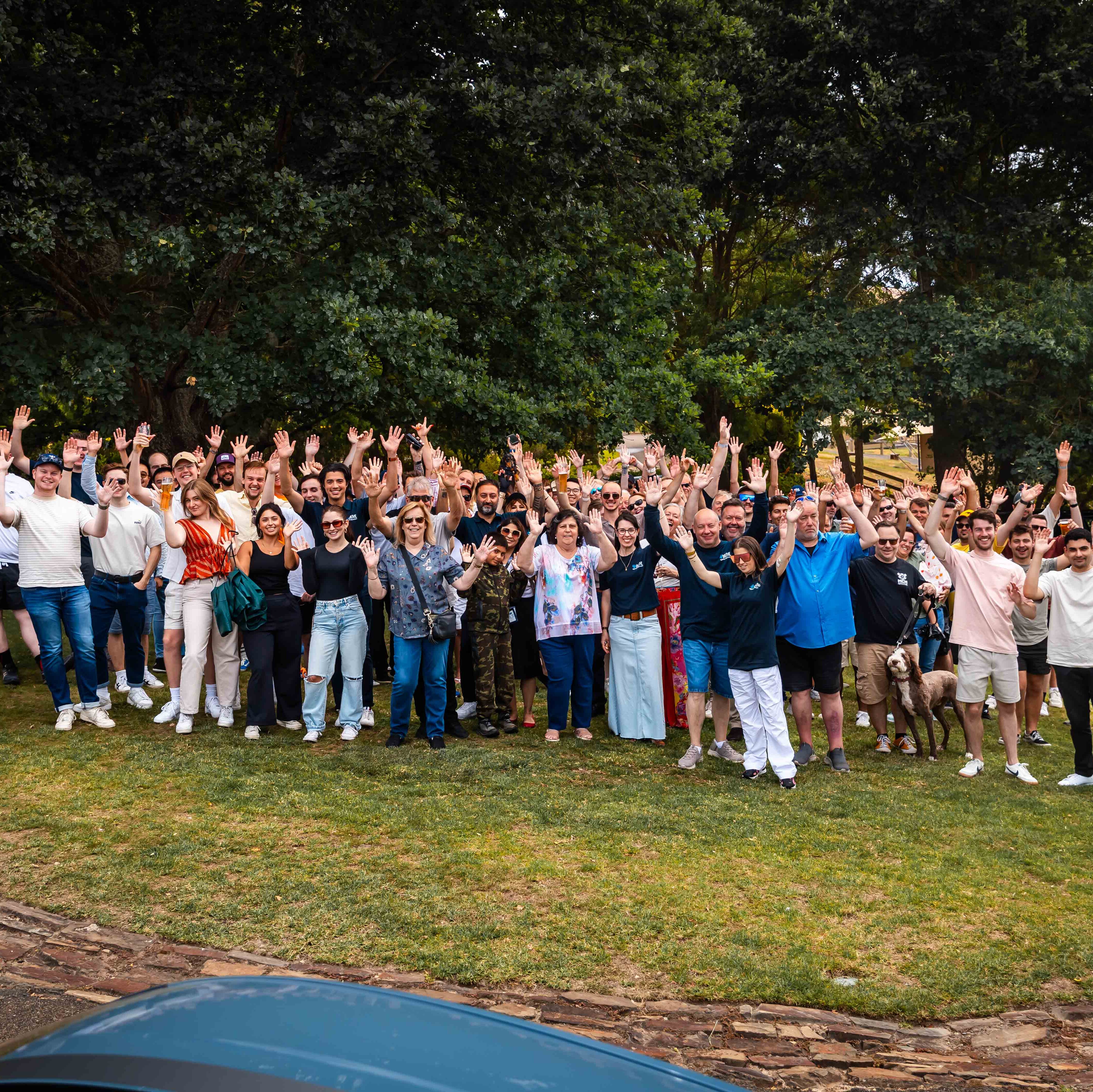 A large group of people with their hands in the air after a drive that advances mental health in Australia.