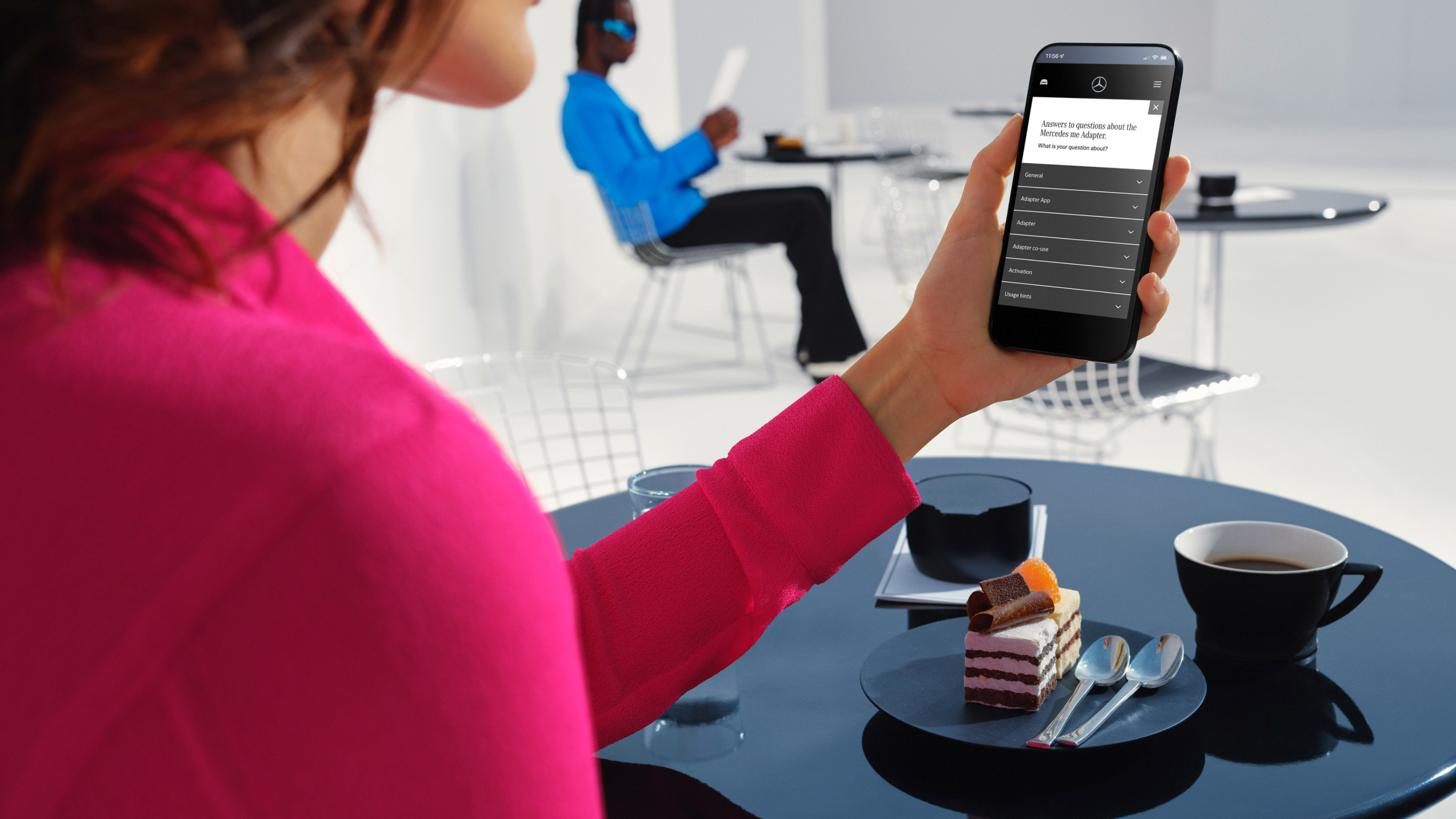 Mercedes-Benz Adapter: Support and FAQs A young man reads answers to frequently asked questions about the Mercedes-Benz Adapter on his smartphone.