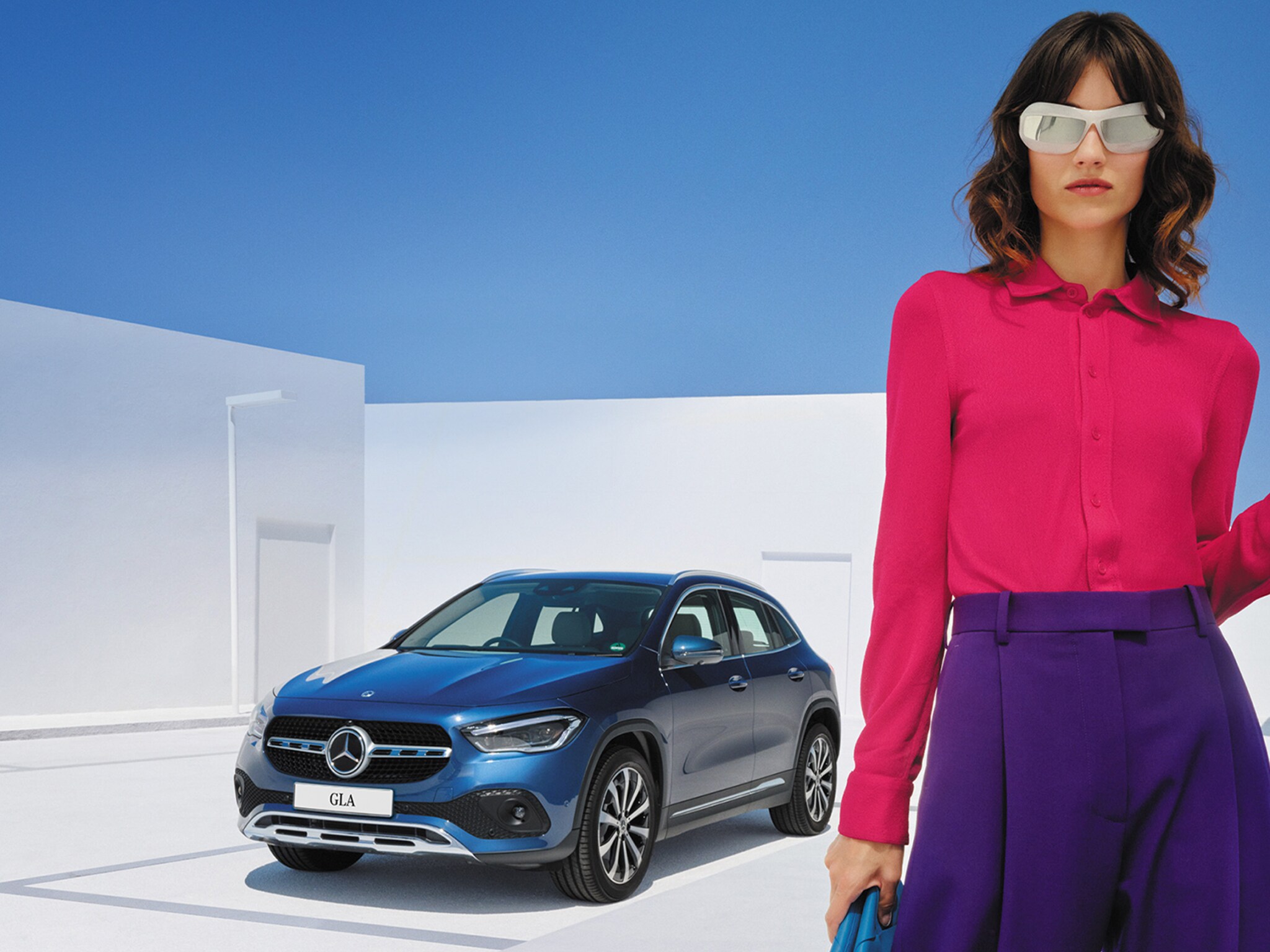 Mercedes-Benz owner standing next to car with phone in hand