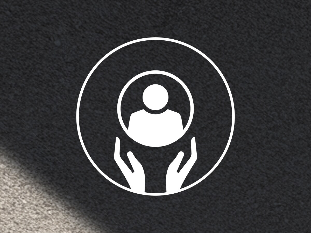 Icon with two hands supporting a human silhouette against a dark background