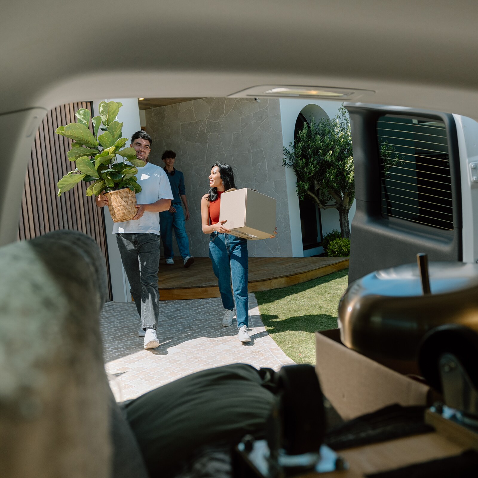 A man and woman loading boxes into a van