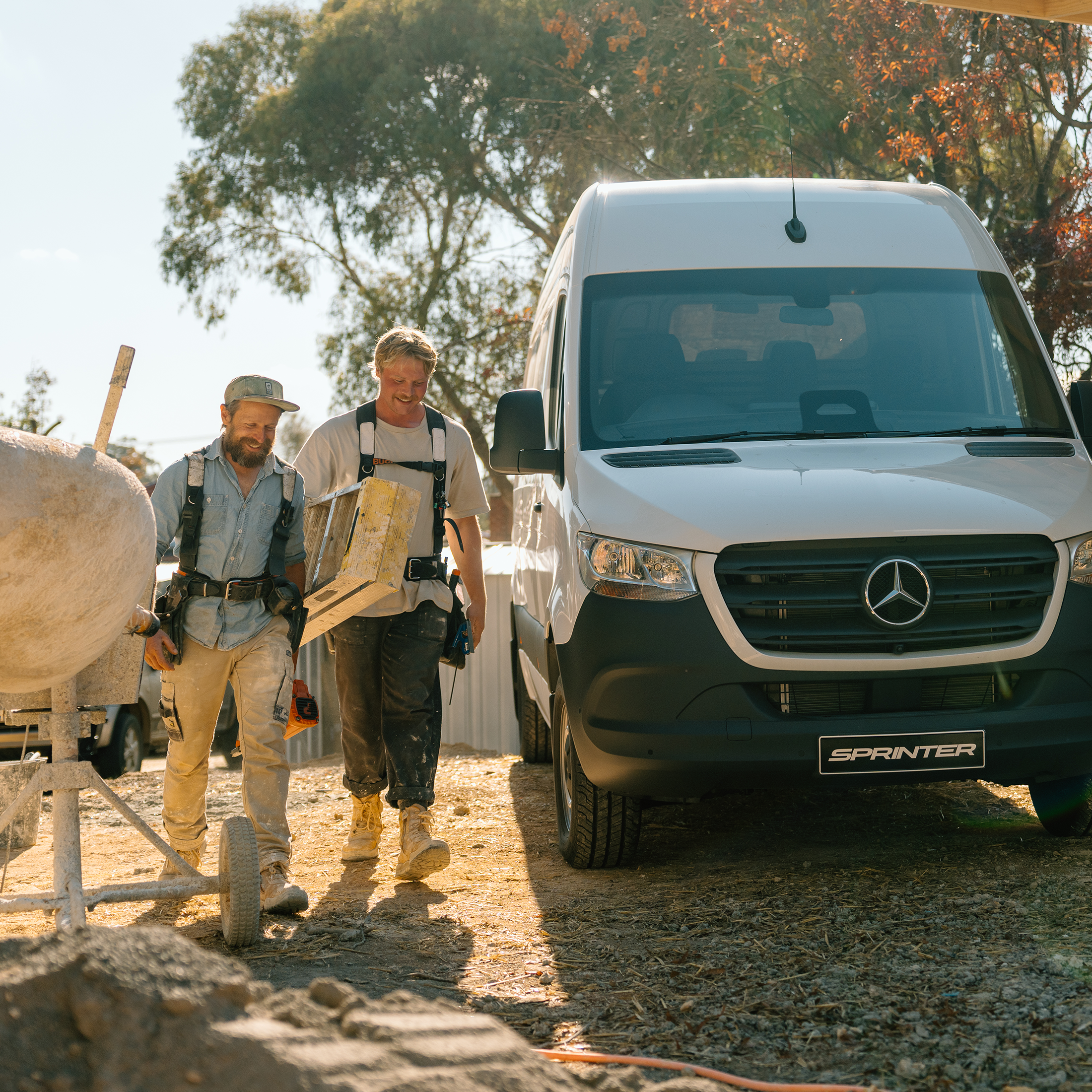 Three people walk past a van, against rural backdrop Three people walk past a van, against rural backdrop